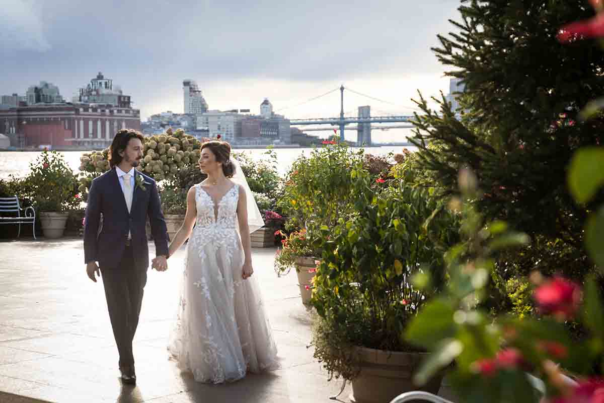 Giando on the Water wedding photos of bride and groom walking across patio 