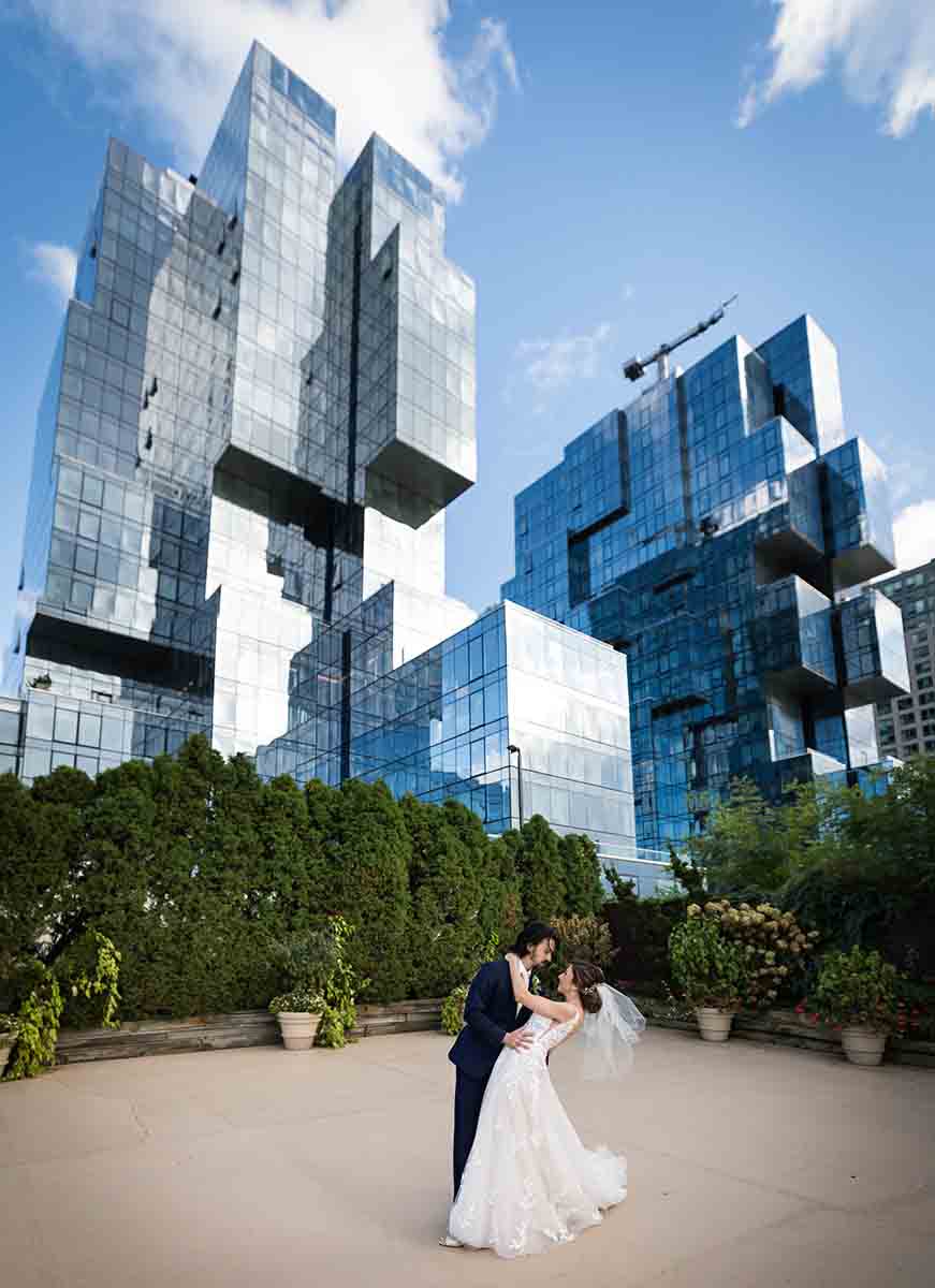 Giando on the Water wedding photos of bride and groom dancing in front of skyscraper 