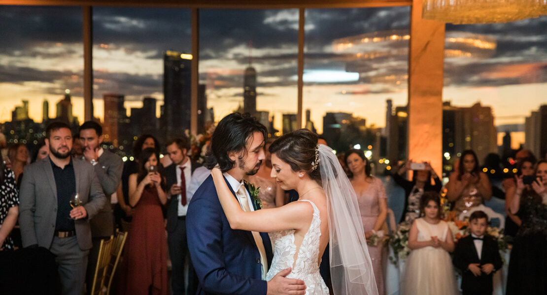 Giando on the Water wedding photos of bride and groom's first dance with NYC skyline in the background