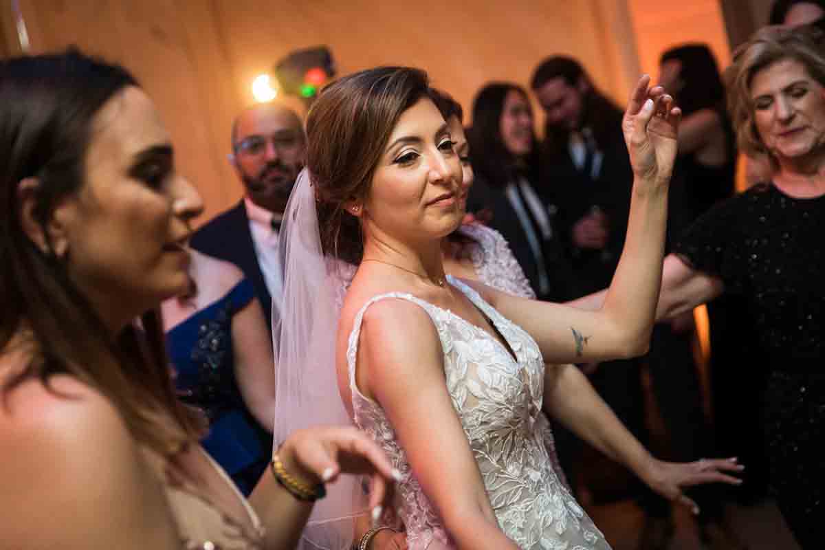 Bride dancing with guests at a Giando on the Water wedding