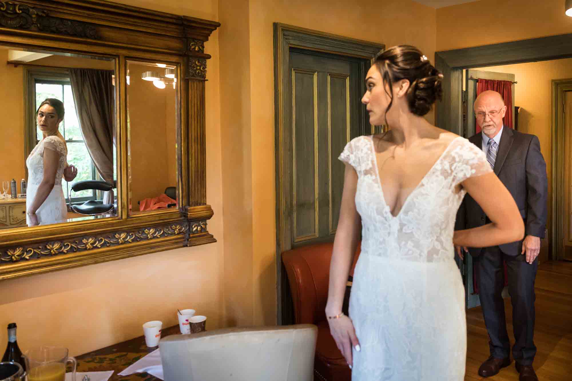 Bride showing dress to father at a FEAST at Round Hill wedding