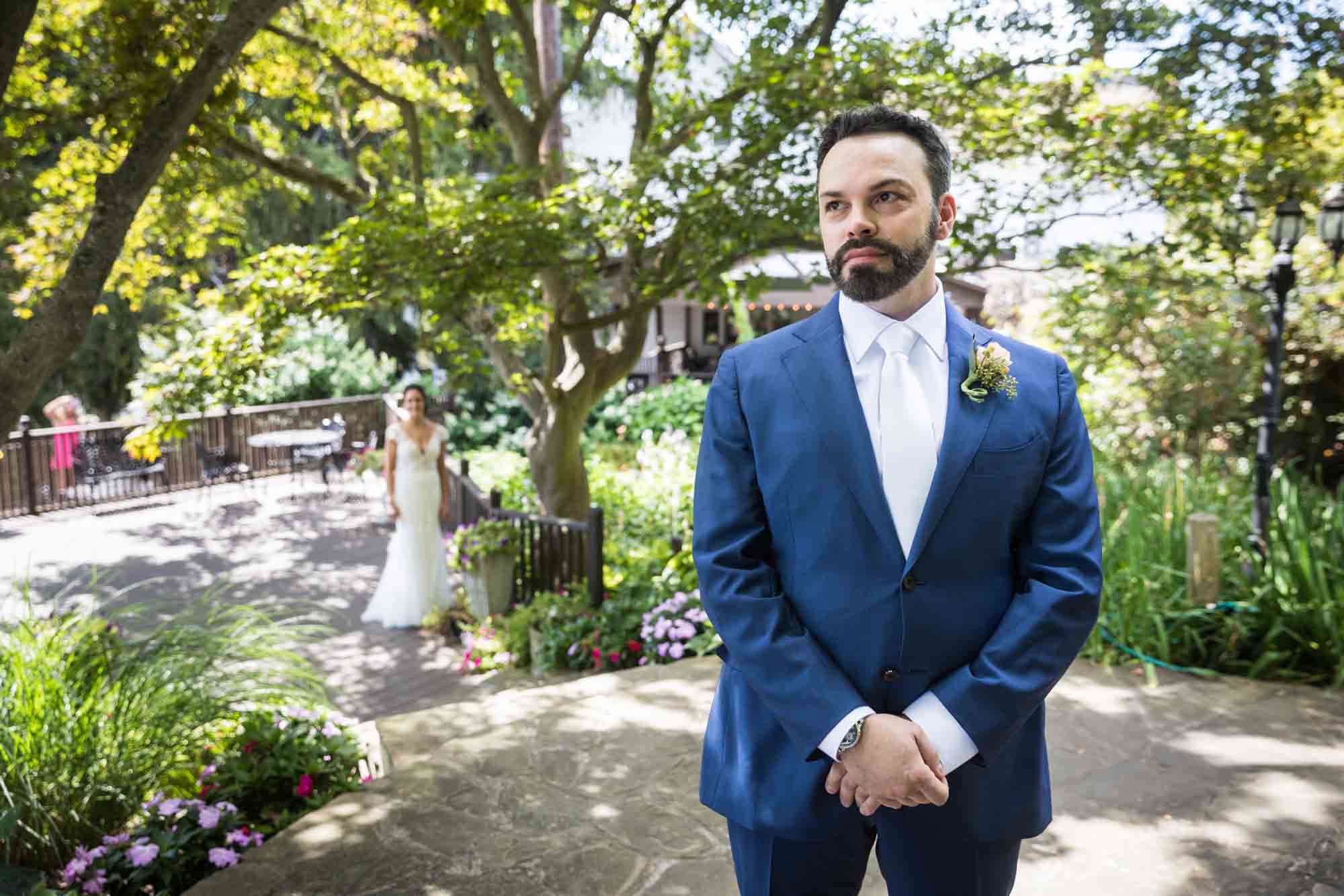 Groom waiting for bride during first look at a FEAST at Round Hill wedding
