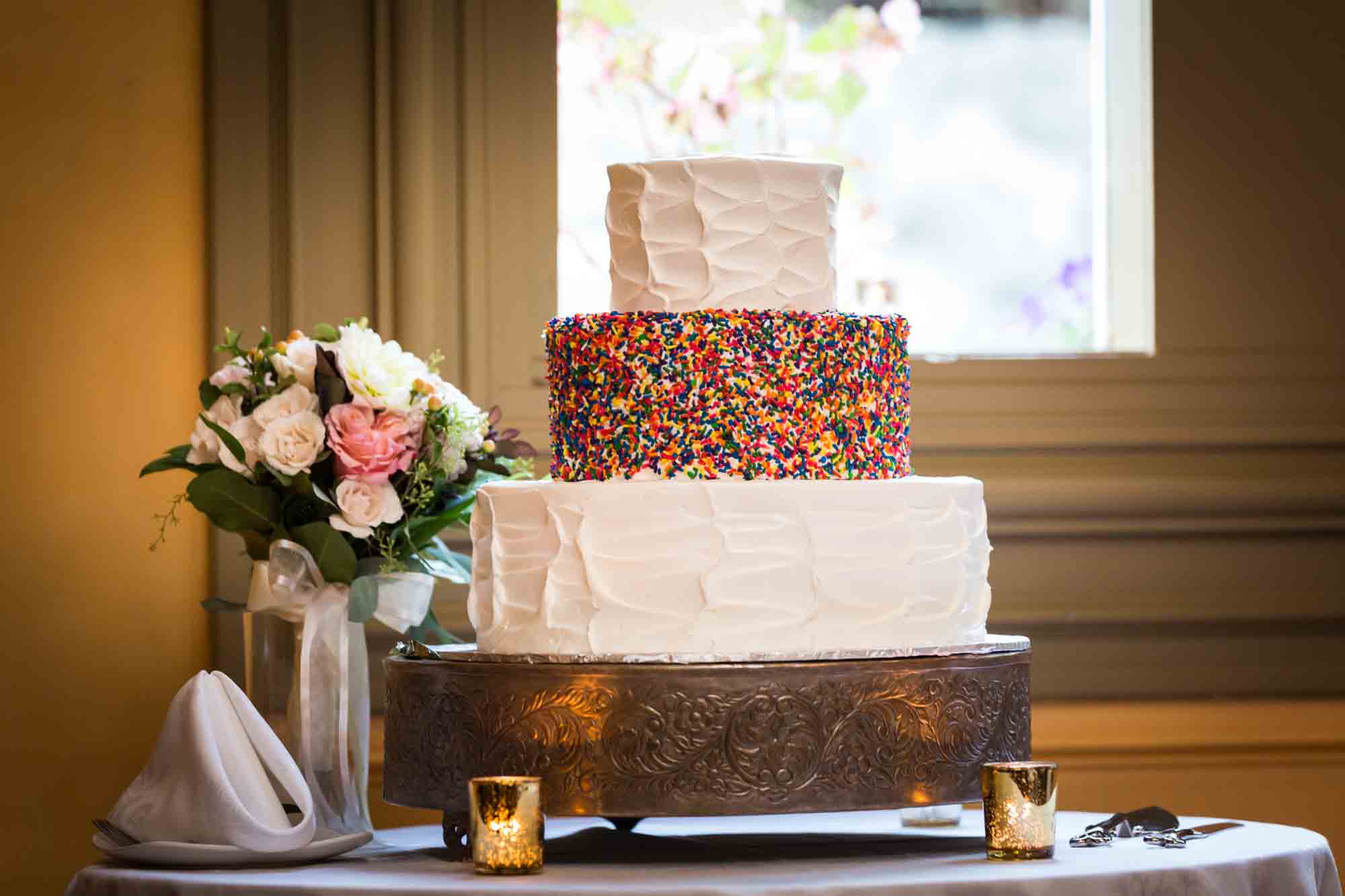 Wedding cake with layer covered in colorful sprinkles