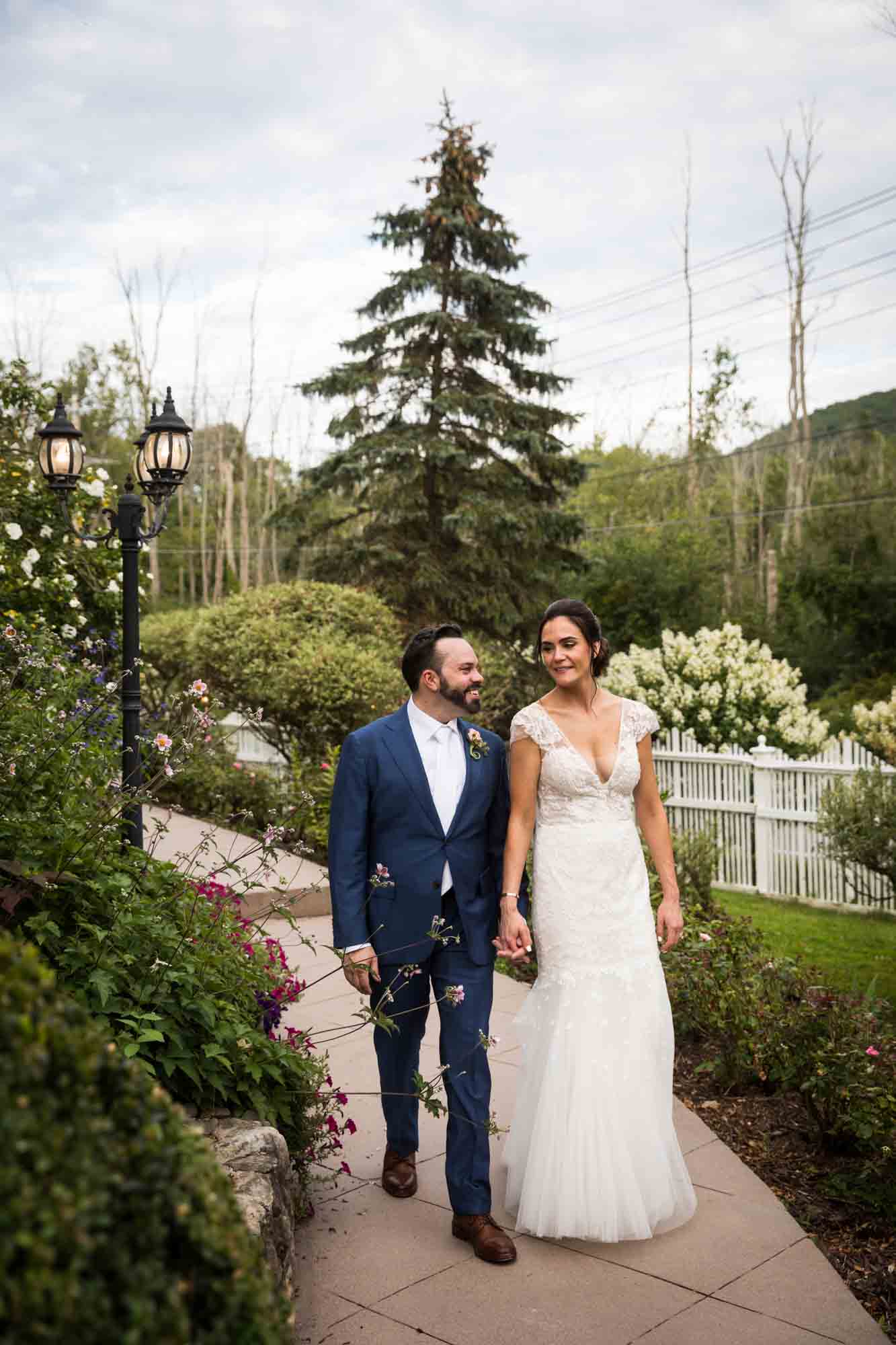 FEAST at Round Hill wedding photos of bride and groom walking through garden