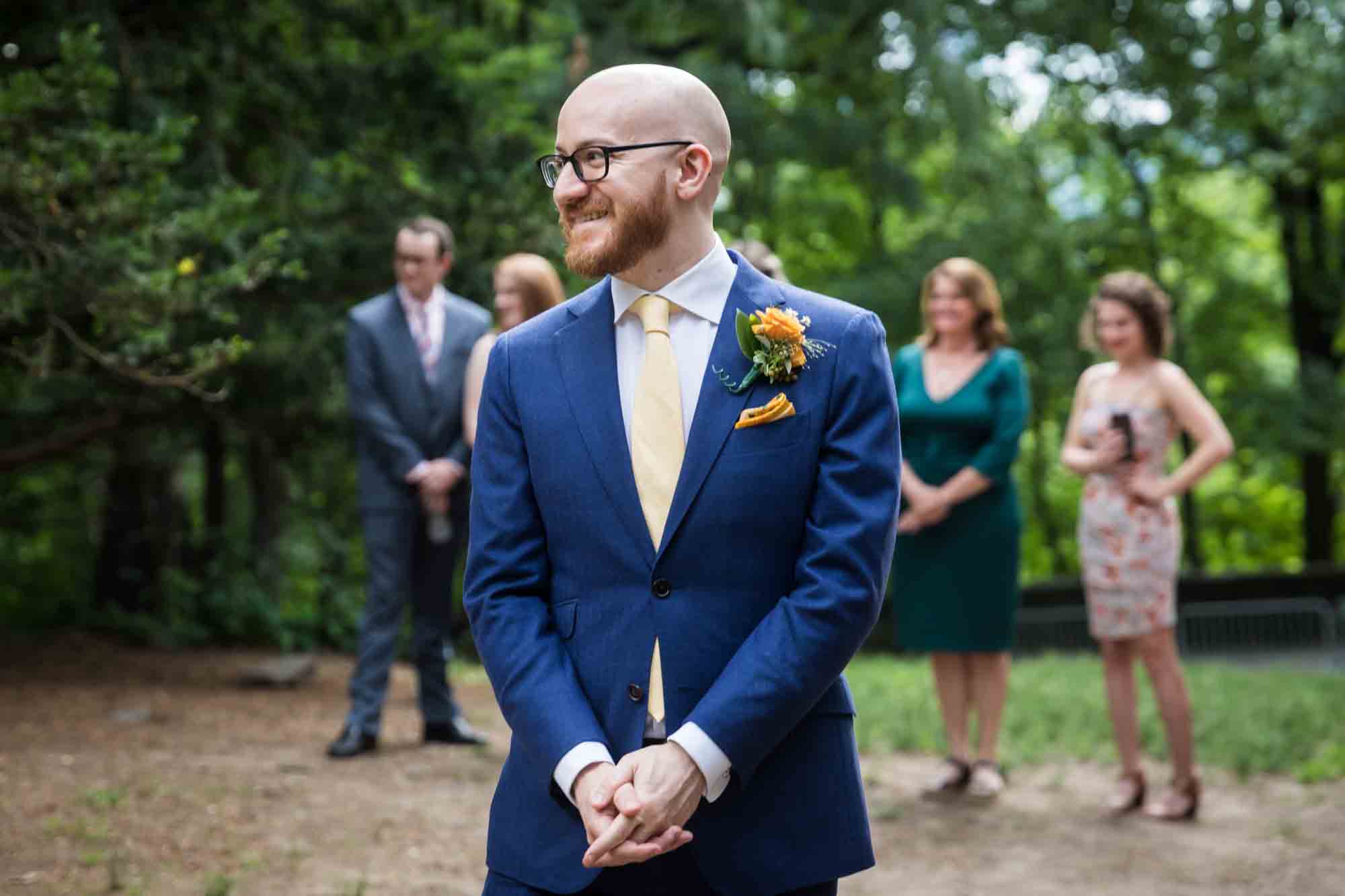 Groom waiting for bride in front of guests for an article on how to select a wedding date