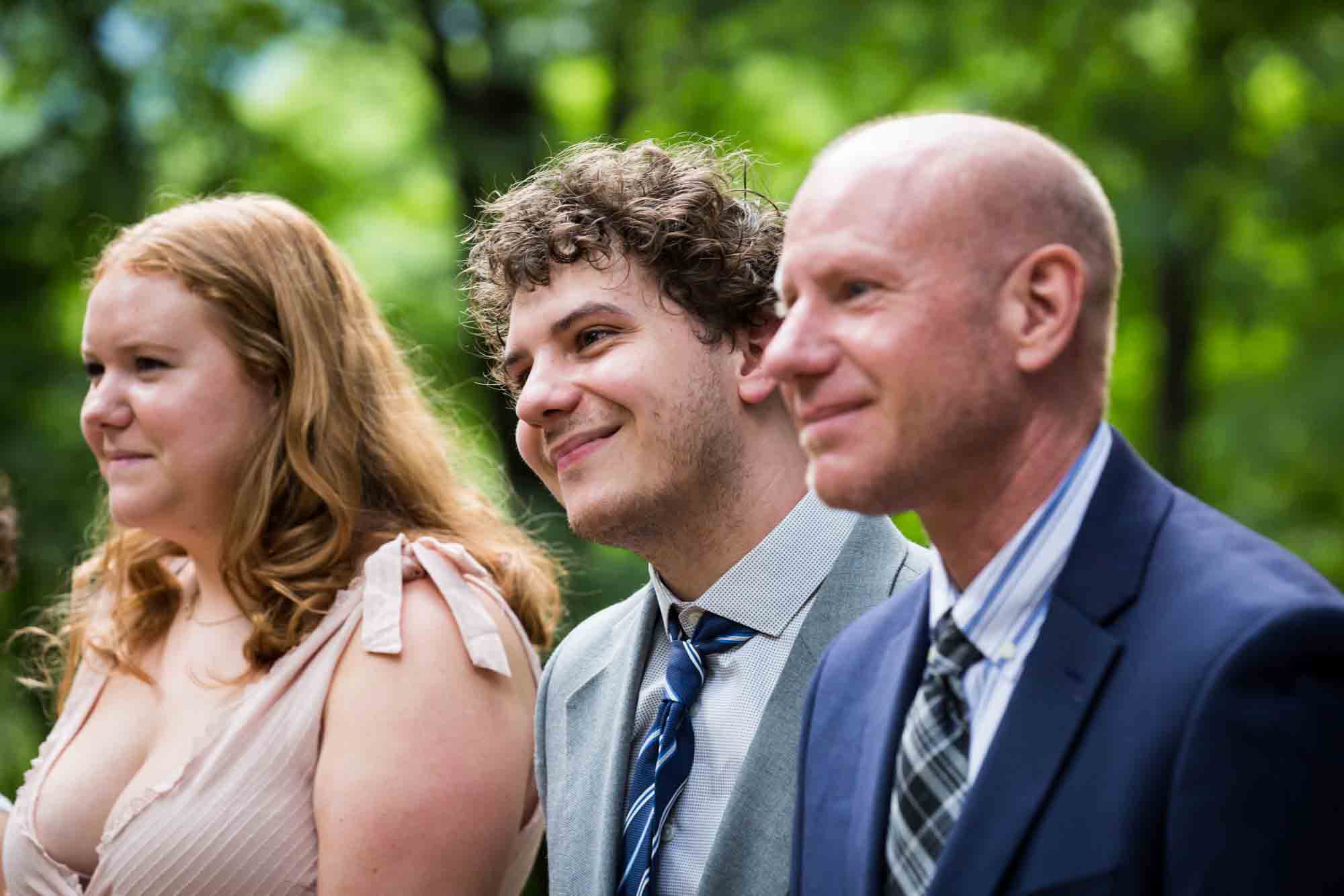 Three guests watching wedding for an article on how to select a wedding date