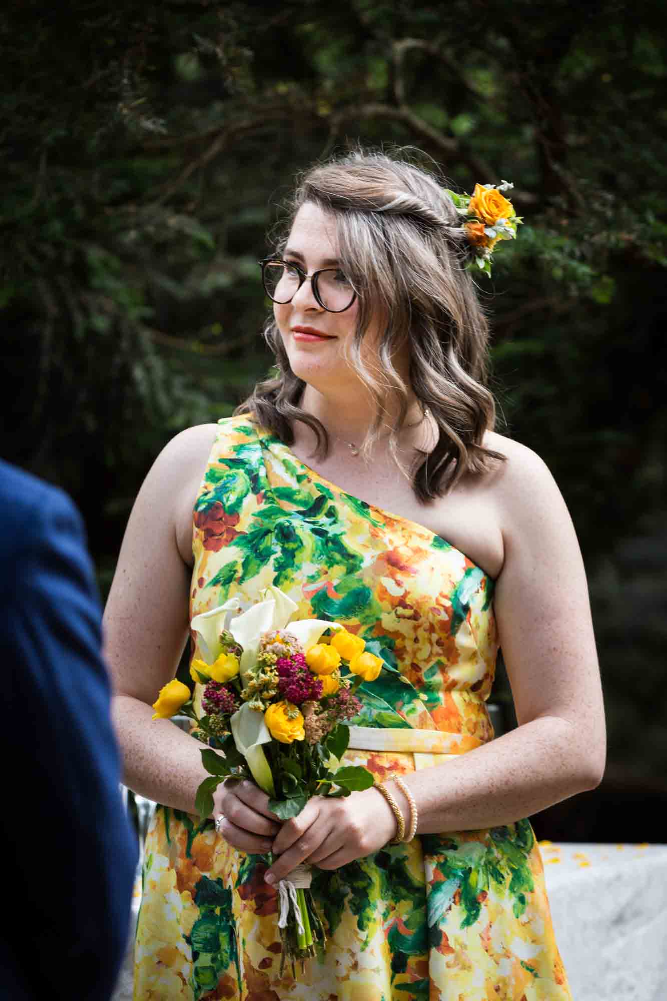 Bride wearing yellow dress and holding yellow flowers for an article on how to select a wedding date