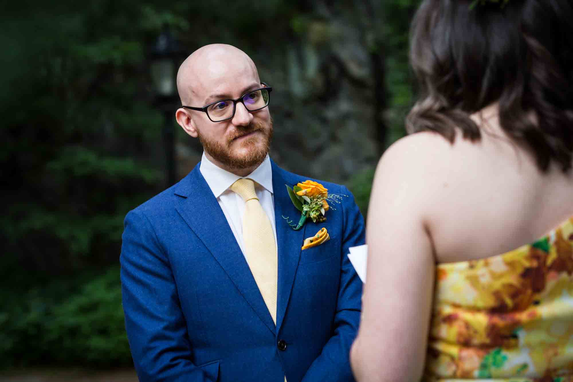 Groom listening to bride say vows for an article on how to select a wedding date