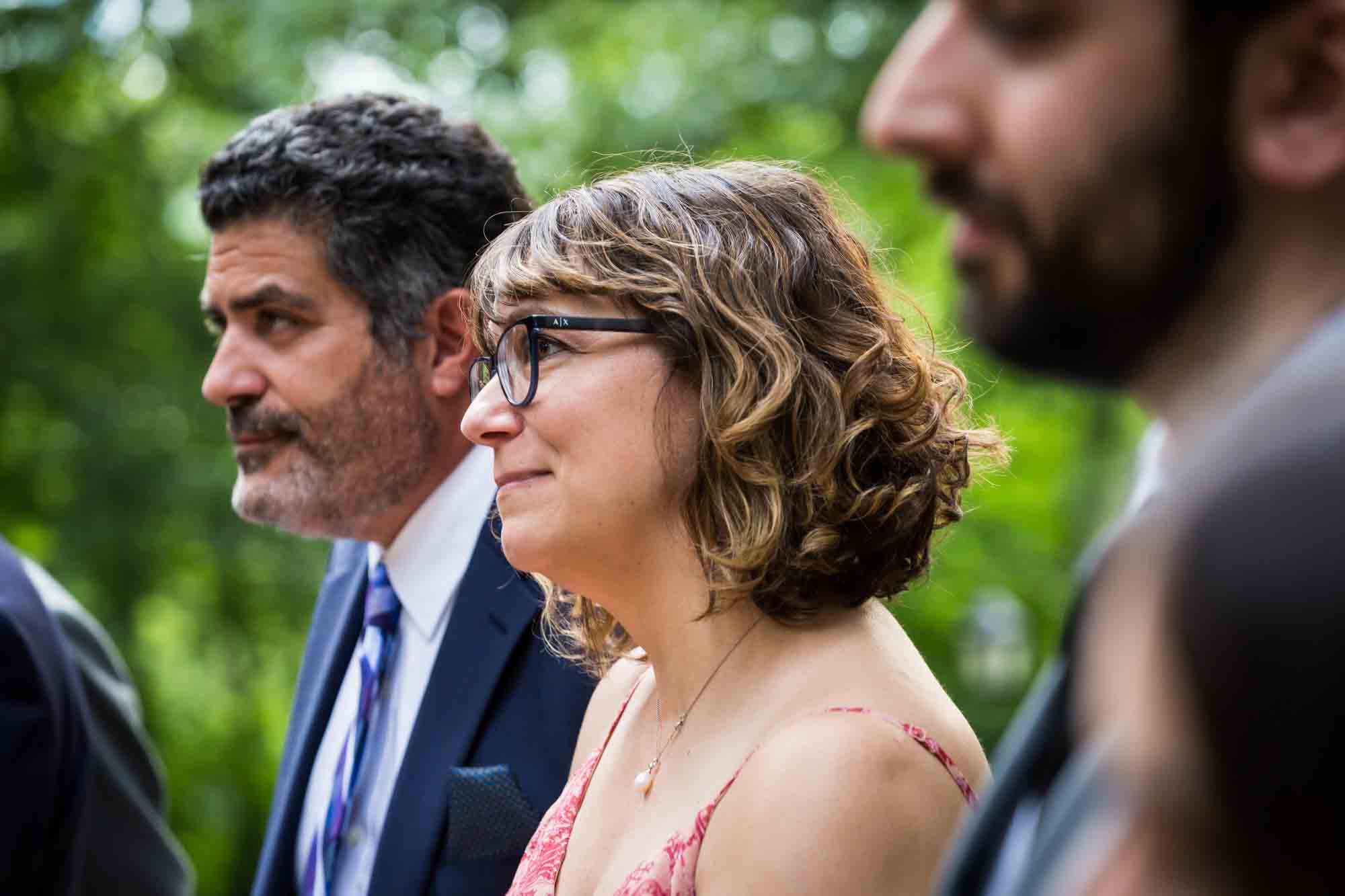 Three guests listening to ceremony for an article on how to select a wedding date