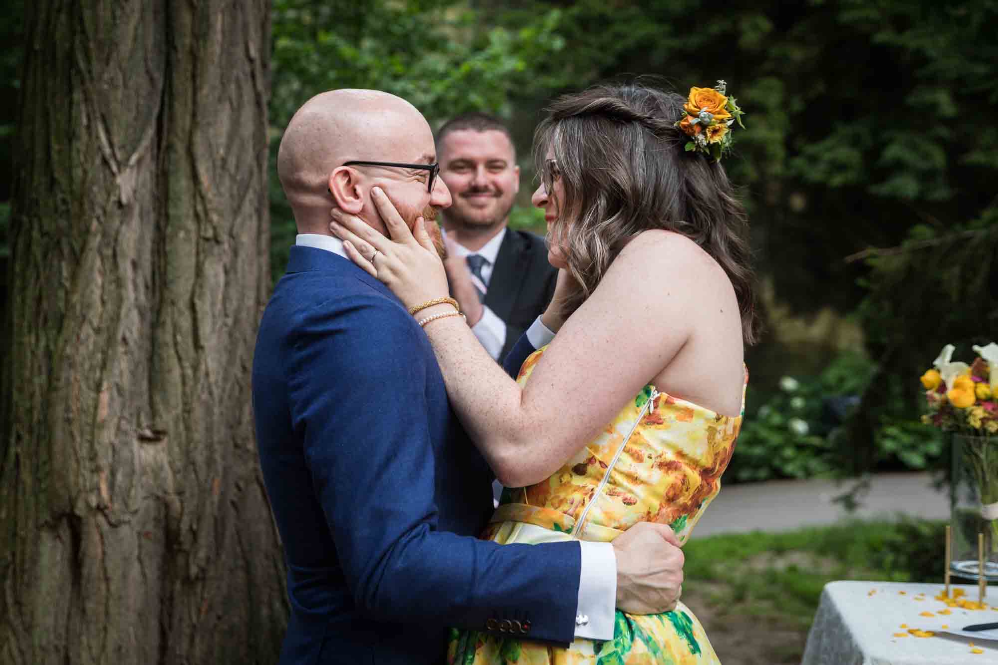 Bride and groom about to kiss in garden for an article on how to select a wedding date