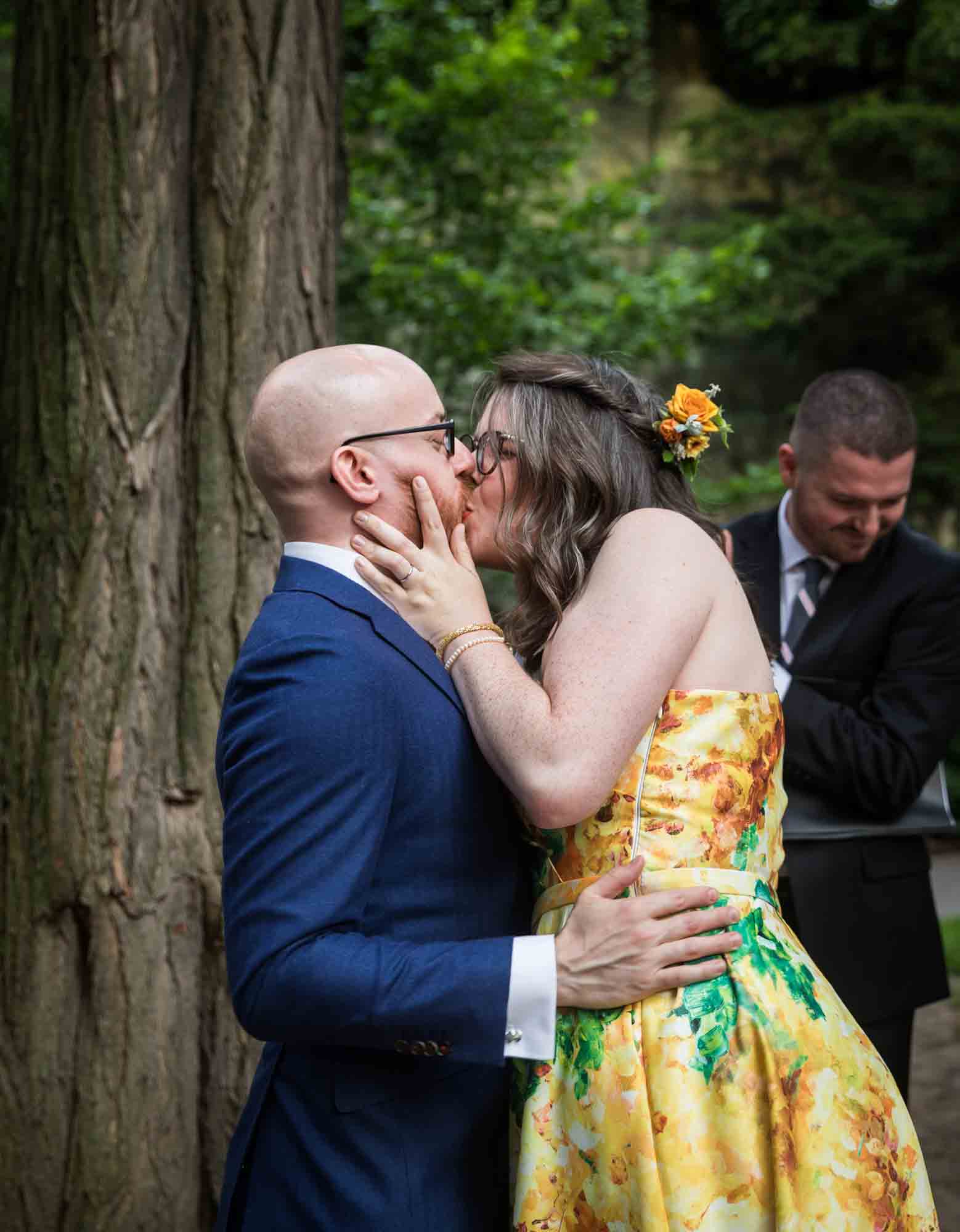 Bride and groom kissing in garden for an article on how to select a wedding date