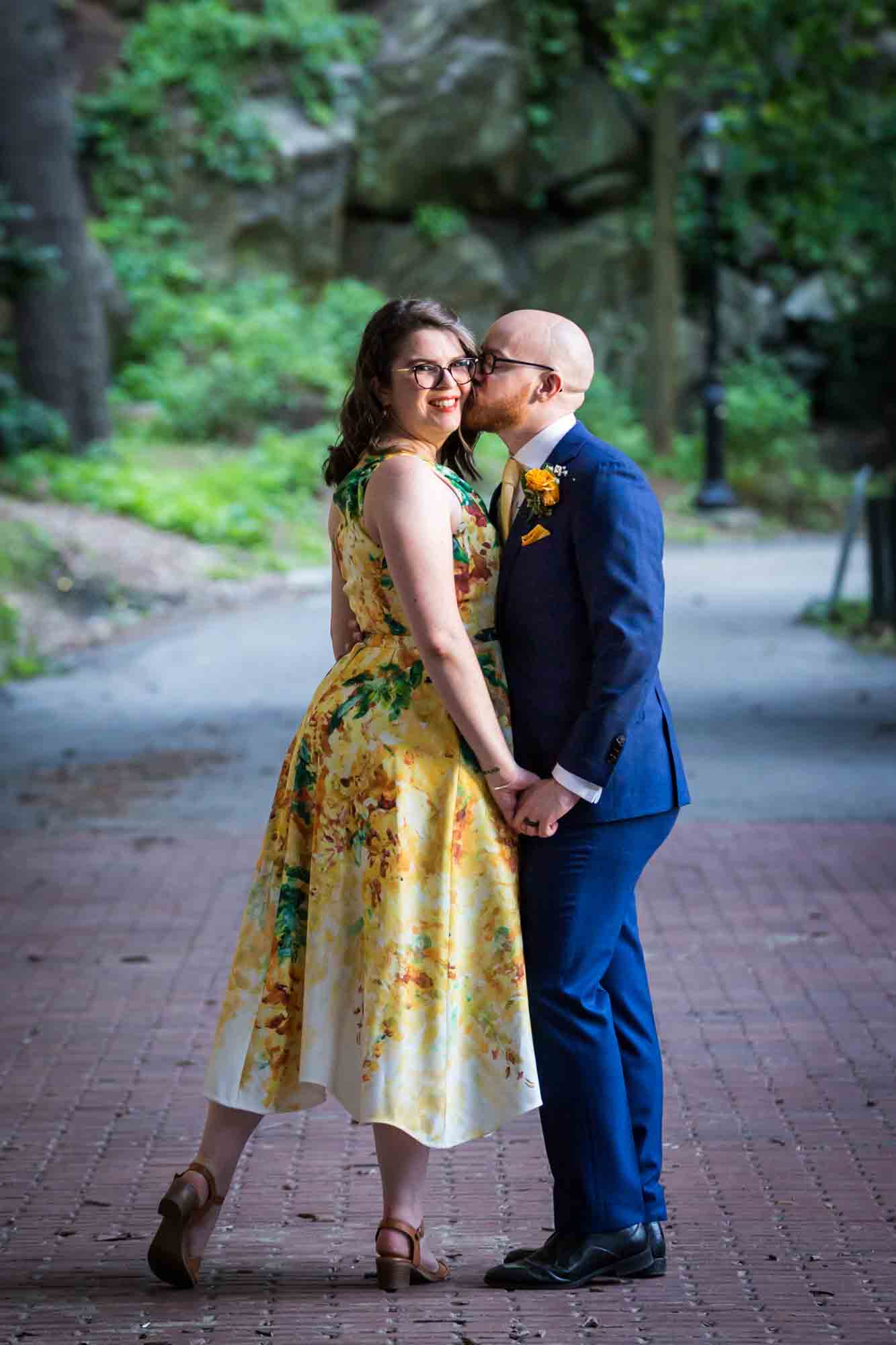 Fort Tryon wedding photos of groom kissing bride on cheek