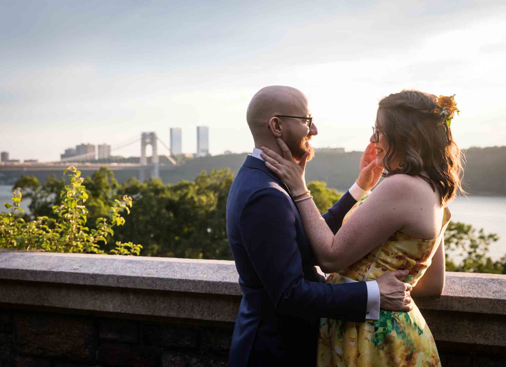 Fort Tryon wedding photos of bride and groom hugging with NYC skyline in background