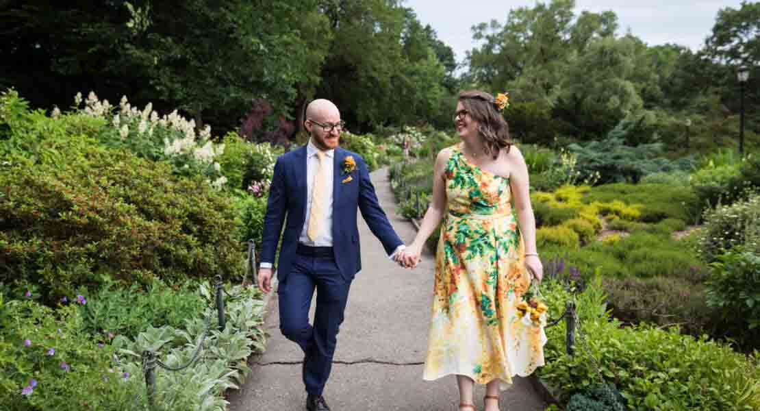 Bride and groom holding hands in Heather Garden for an article on how to select a wedding date