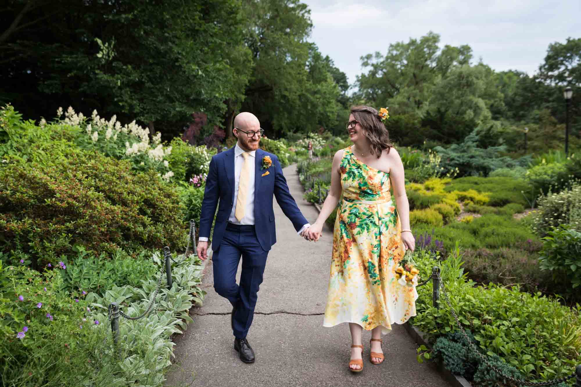 Bride and groom holding hands in Heather Garden for an article on how to select a wedding date