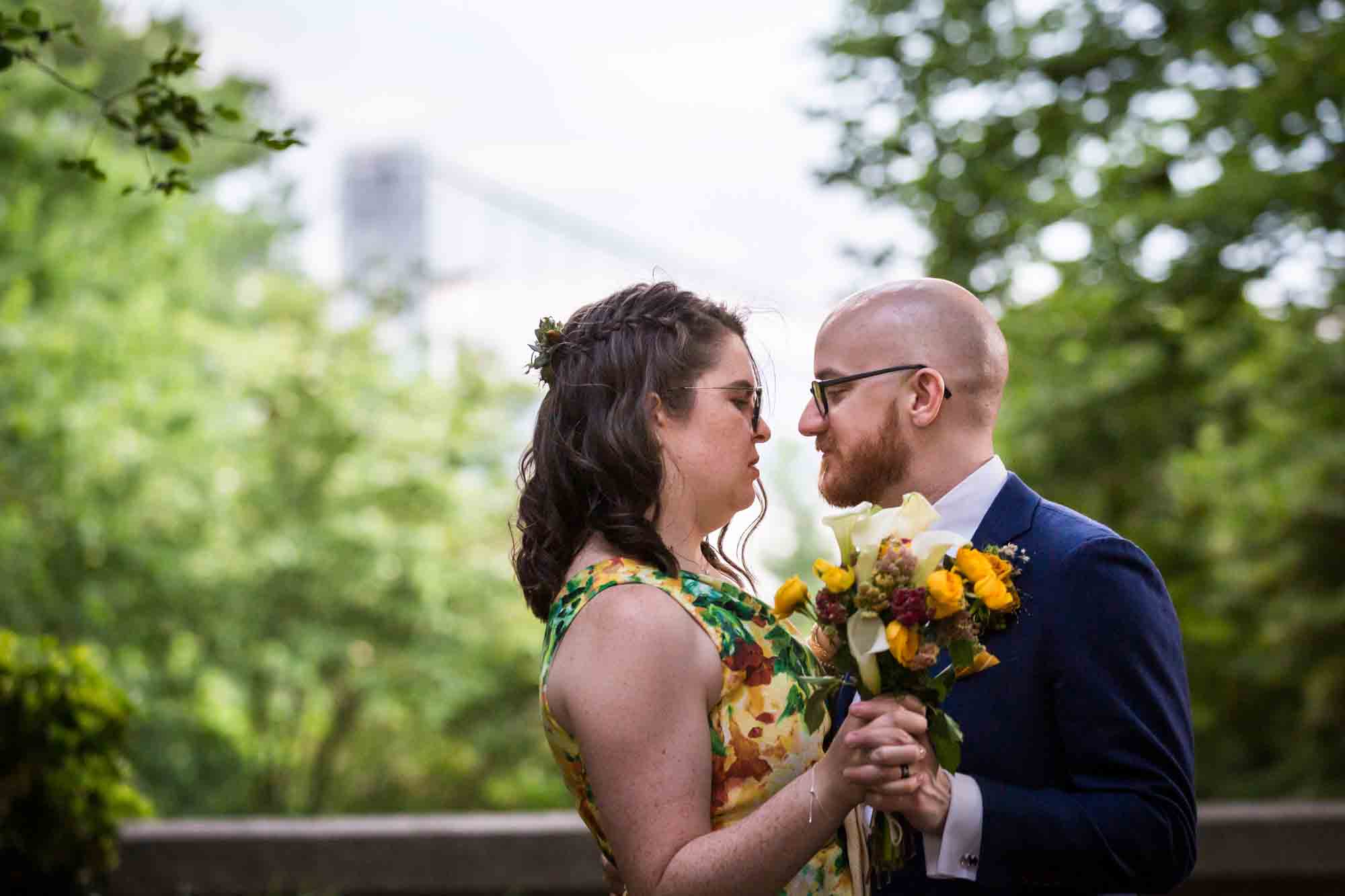 Bride and groom dancing in with bridge in background for an article on how to select a wedding date