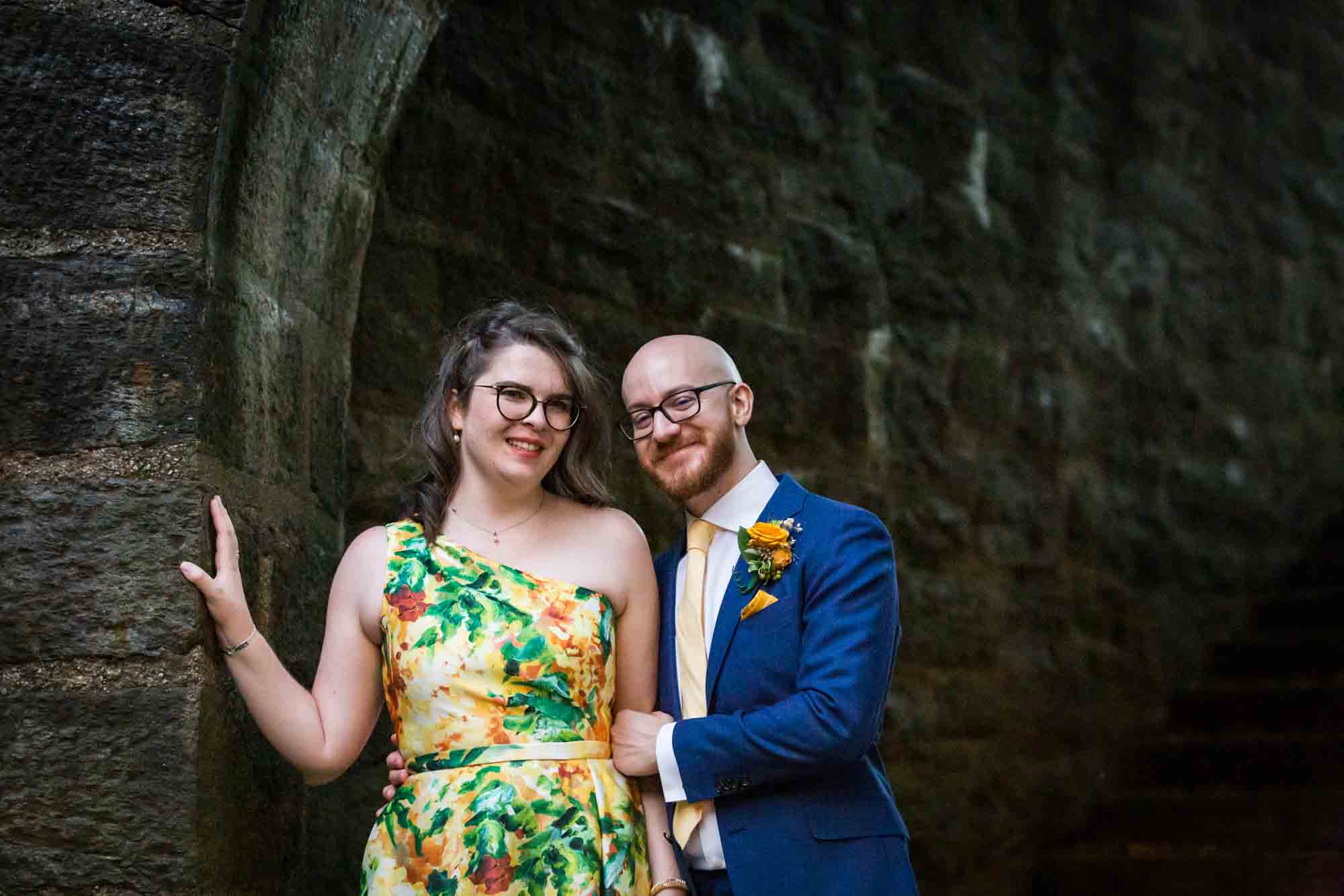Fort Tryon wedding photos of bride and groom hugging under stone arch