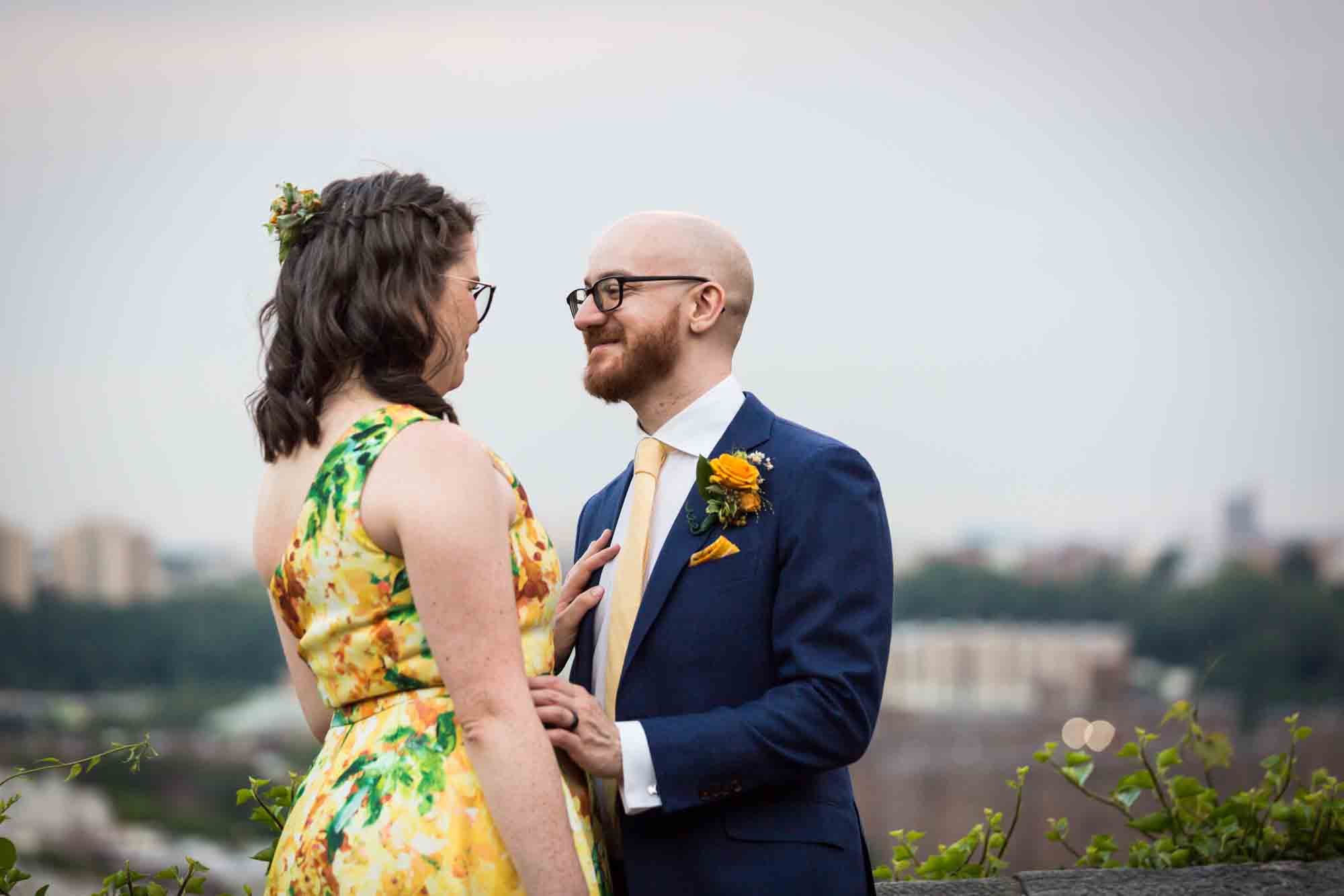 Fort Tryon wedding photos of groom looking at bride wearing yellow dress