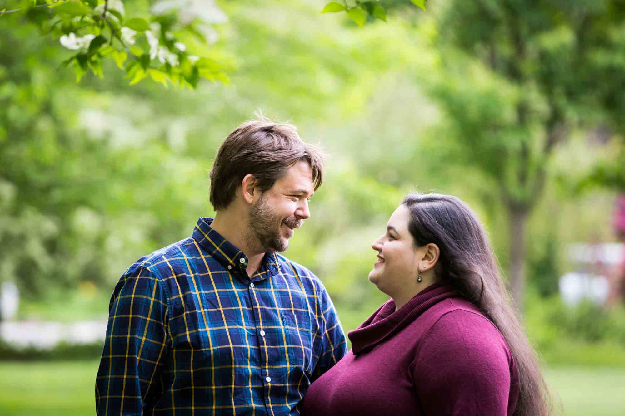 Snug Harbor engagement photos of couple looking at each other in garden