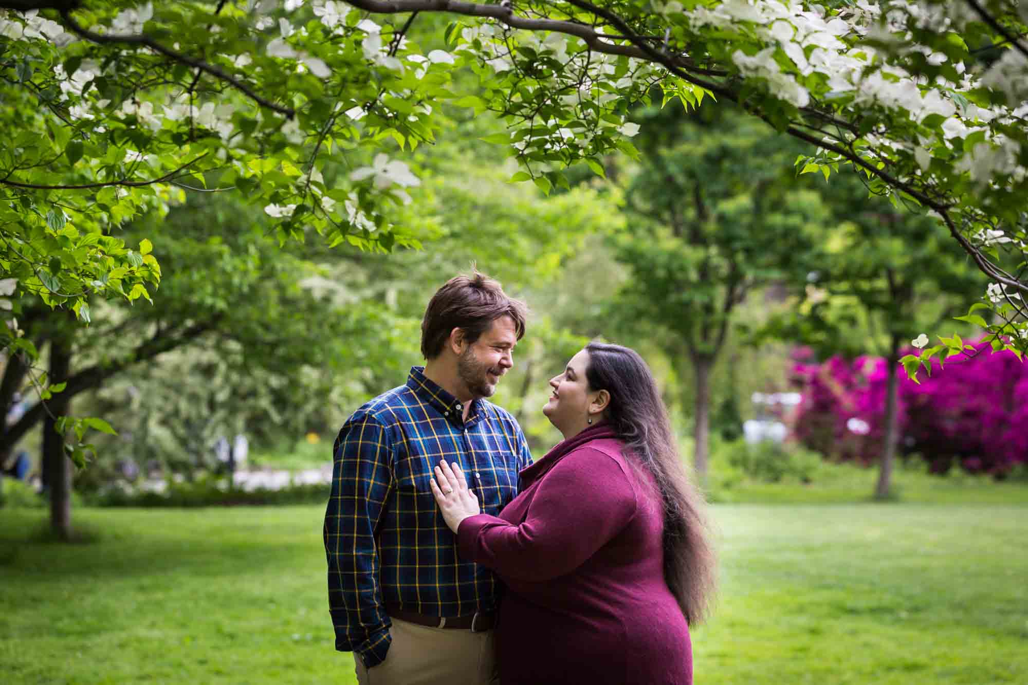 Snug Harbor engagement photos of couple looking at each other in garden