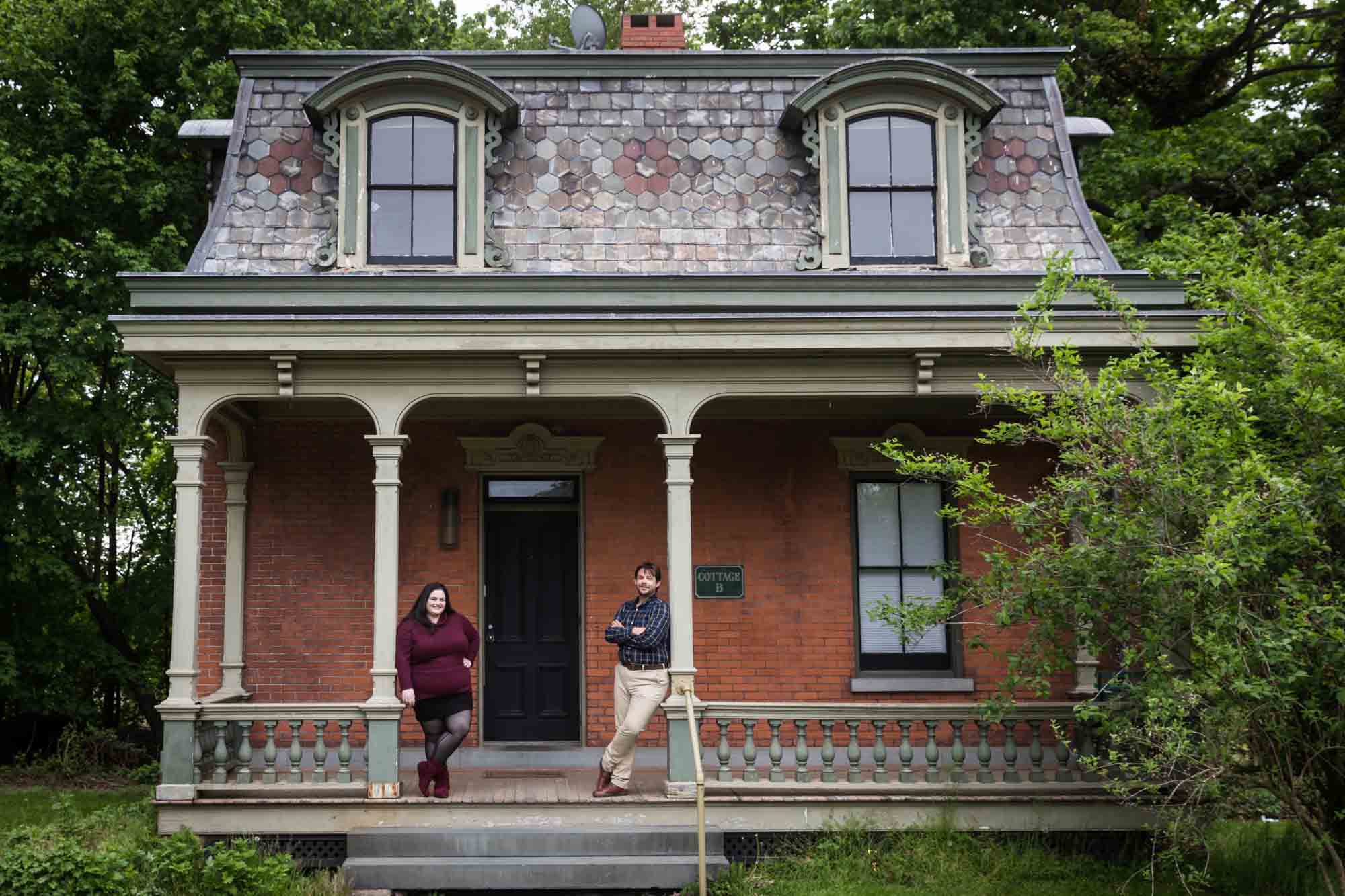Snug Harbor engagement photos of couple standing on steps of Cottage Row house