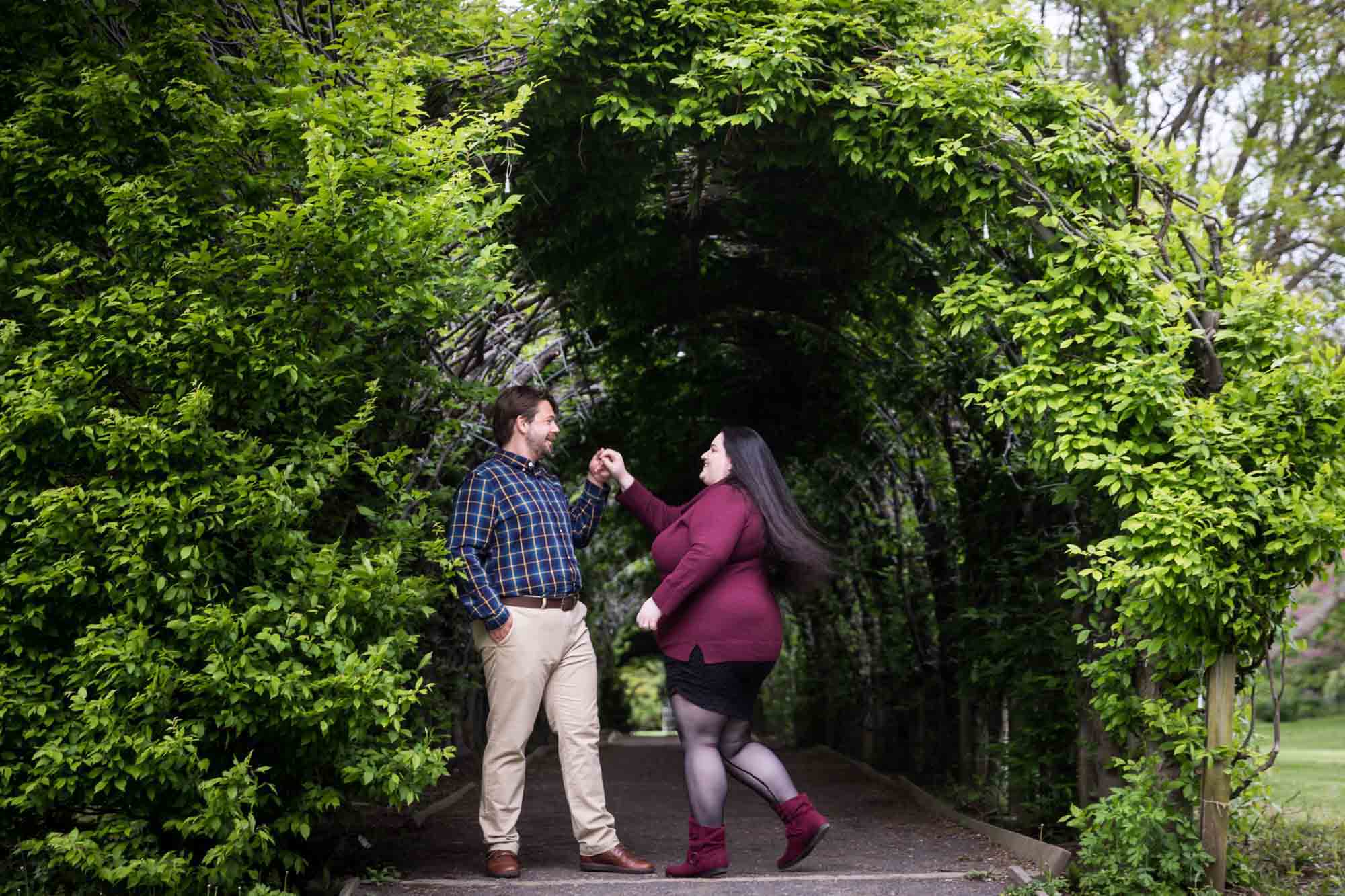 Snug Harbor engagement photos of couple dancing under allee