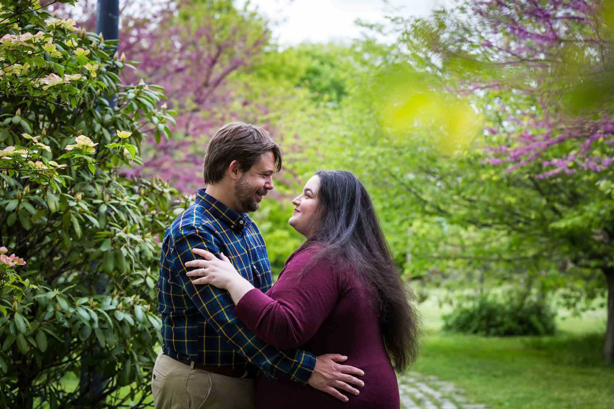 Snug Harbor engagement photos of couple looking at each other in garden