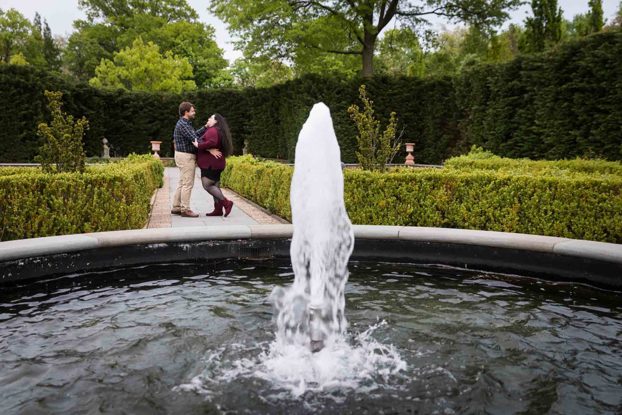 Couple dancing in Tuscan Garden behind fountain in Snug Harbor