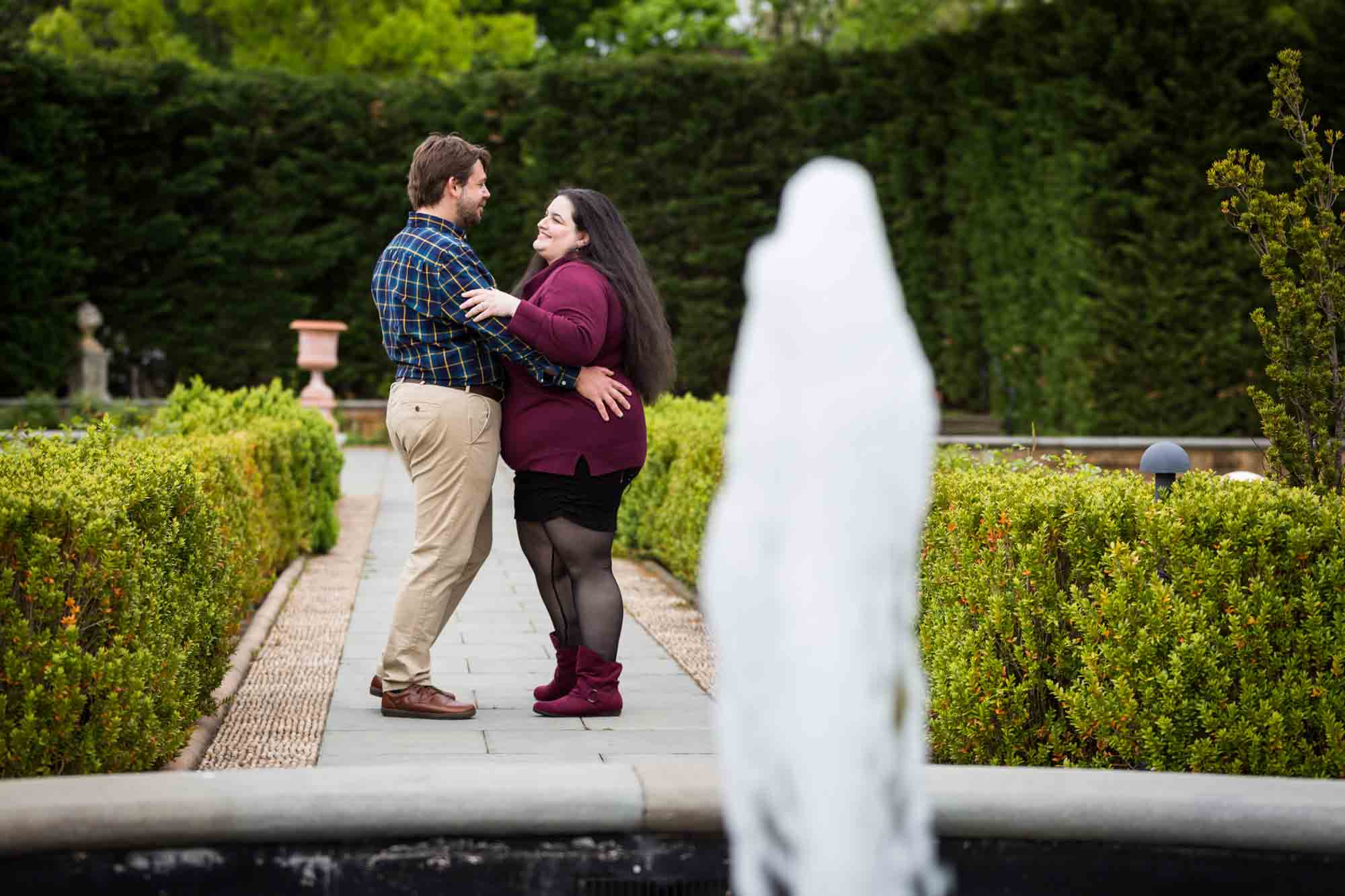 Couple dancing behind fountain in Tuscan Garden in Snug Harbor