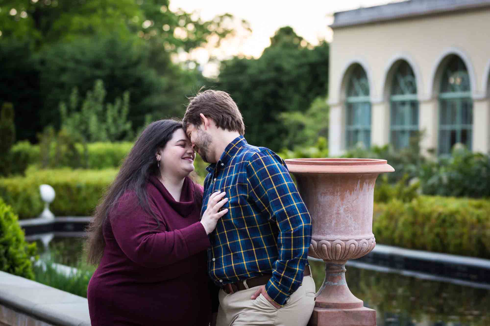 Couple touching foreheads in Tuscan Garden in Snug Harbor
