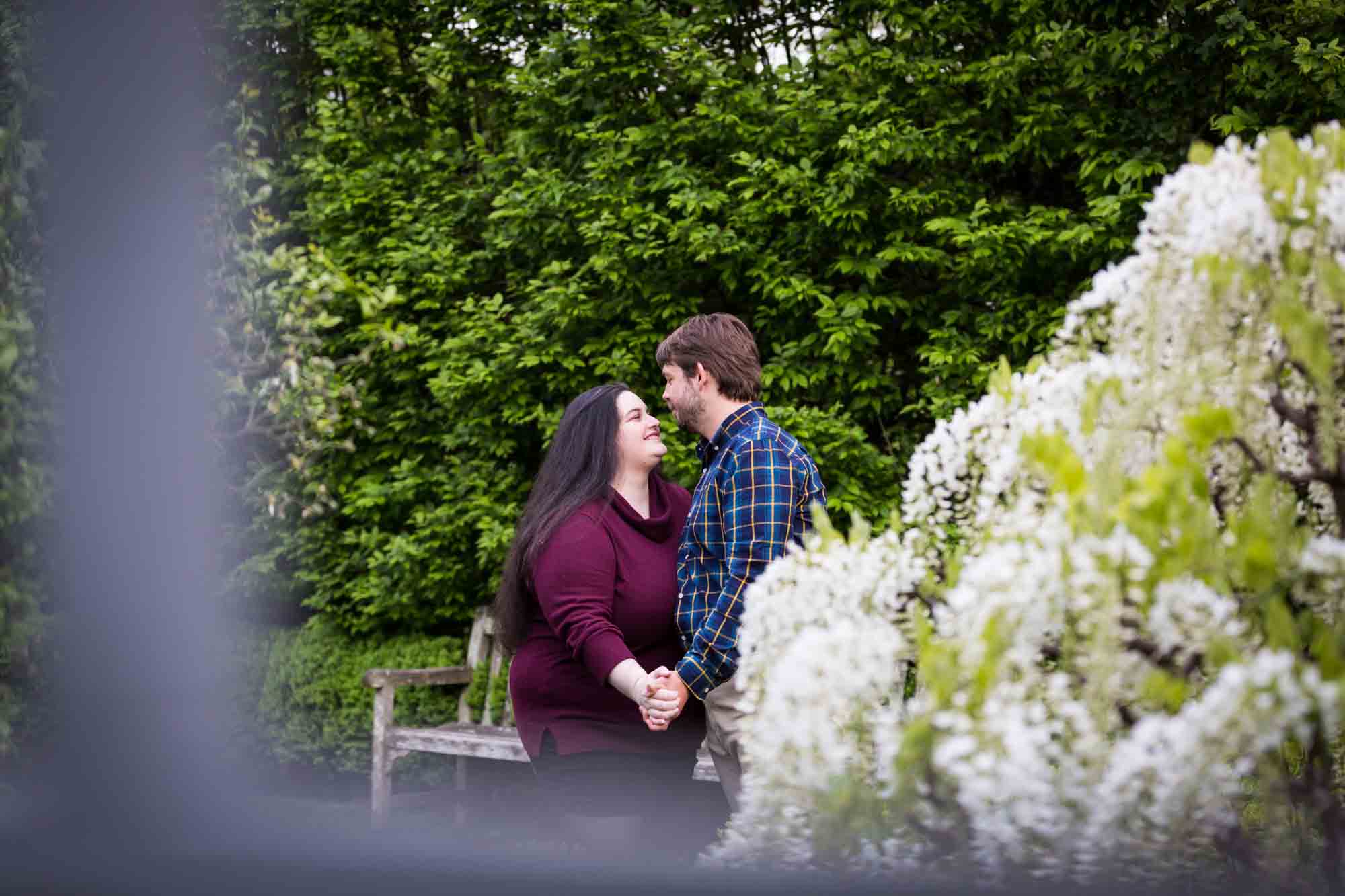 Couple about to kiss in White Garden in Snug Harbor