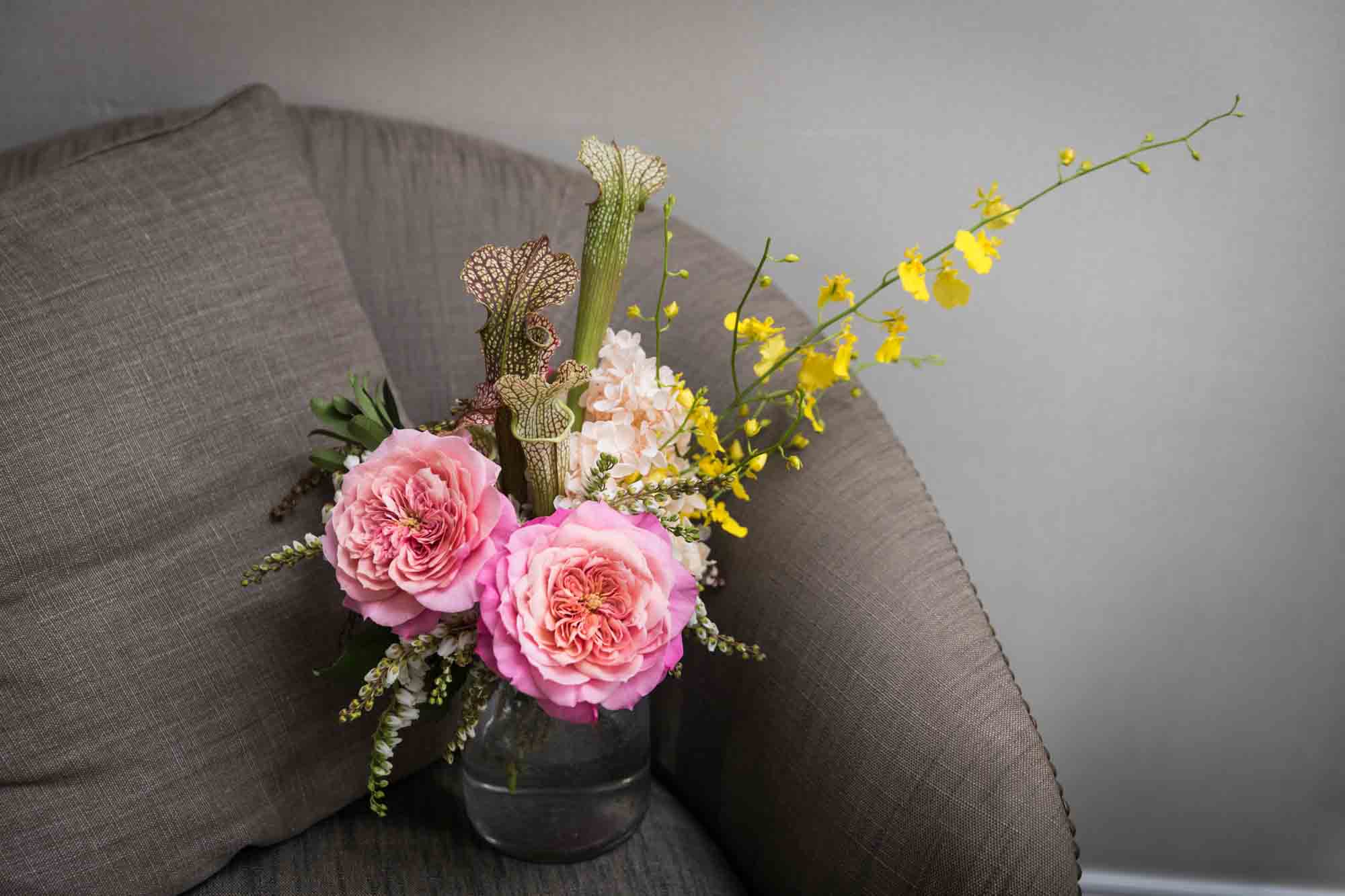 Pink and yellow flower bouquet on a chair for article on wedding bouquet photo tips