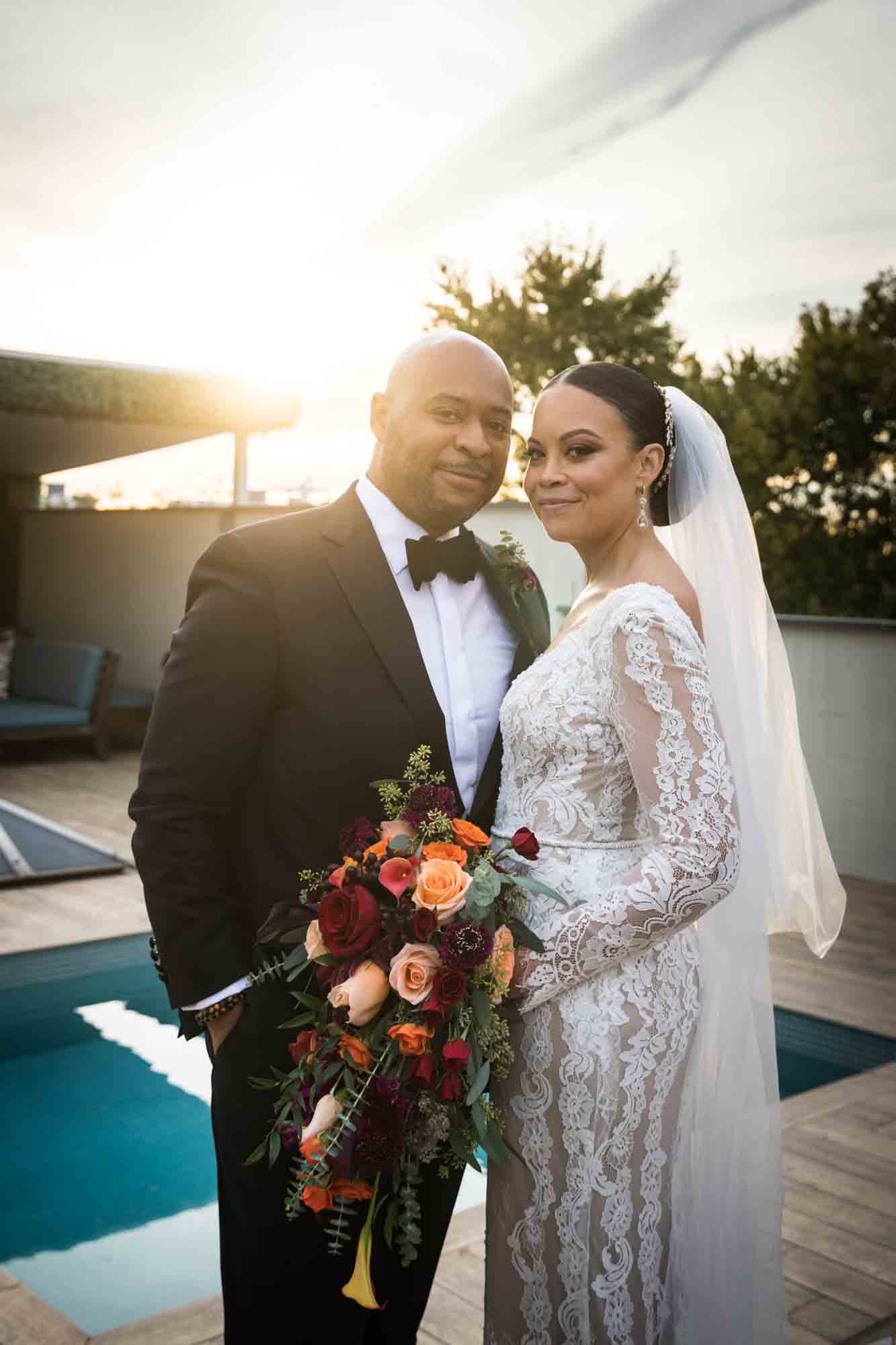 Bride and groom at sunset on roof