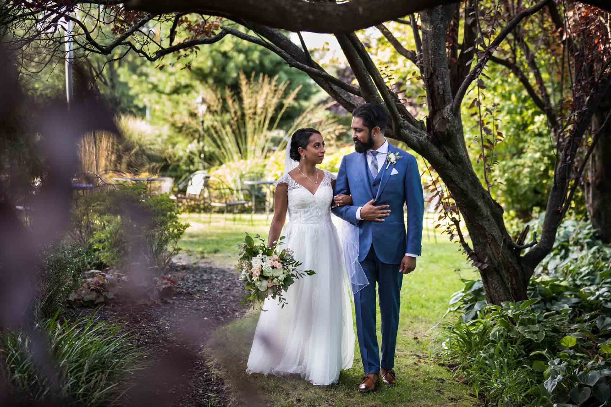 Bride and groom walking in garden