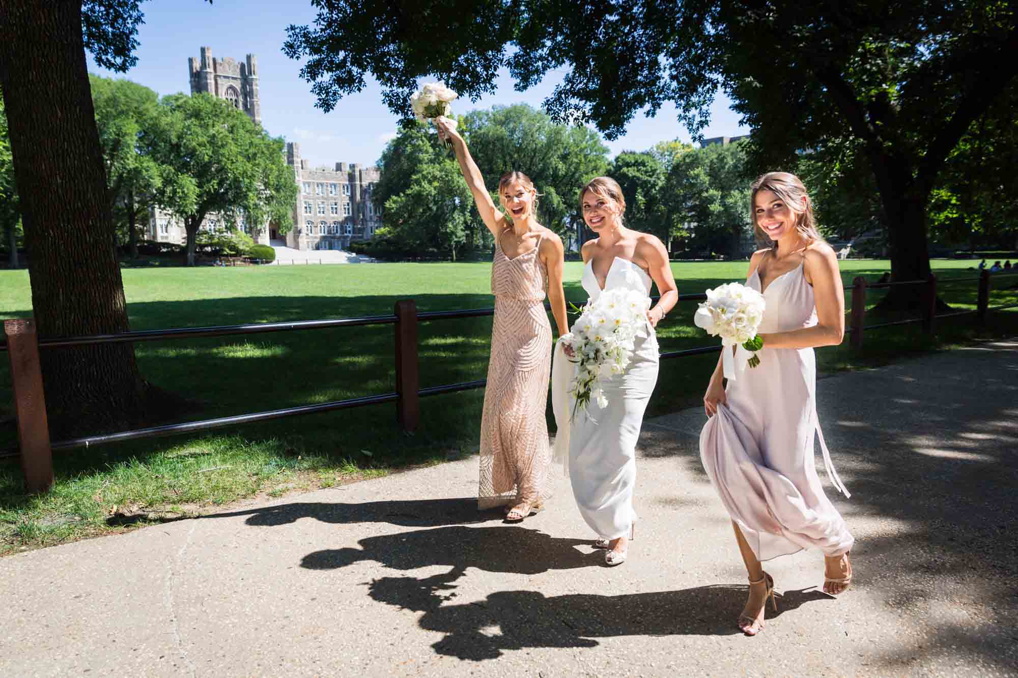 Bride and two bridesmaids walking along pathway for article on wedding bouquet photo tips