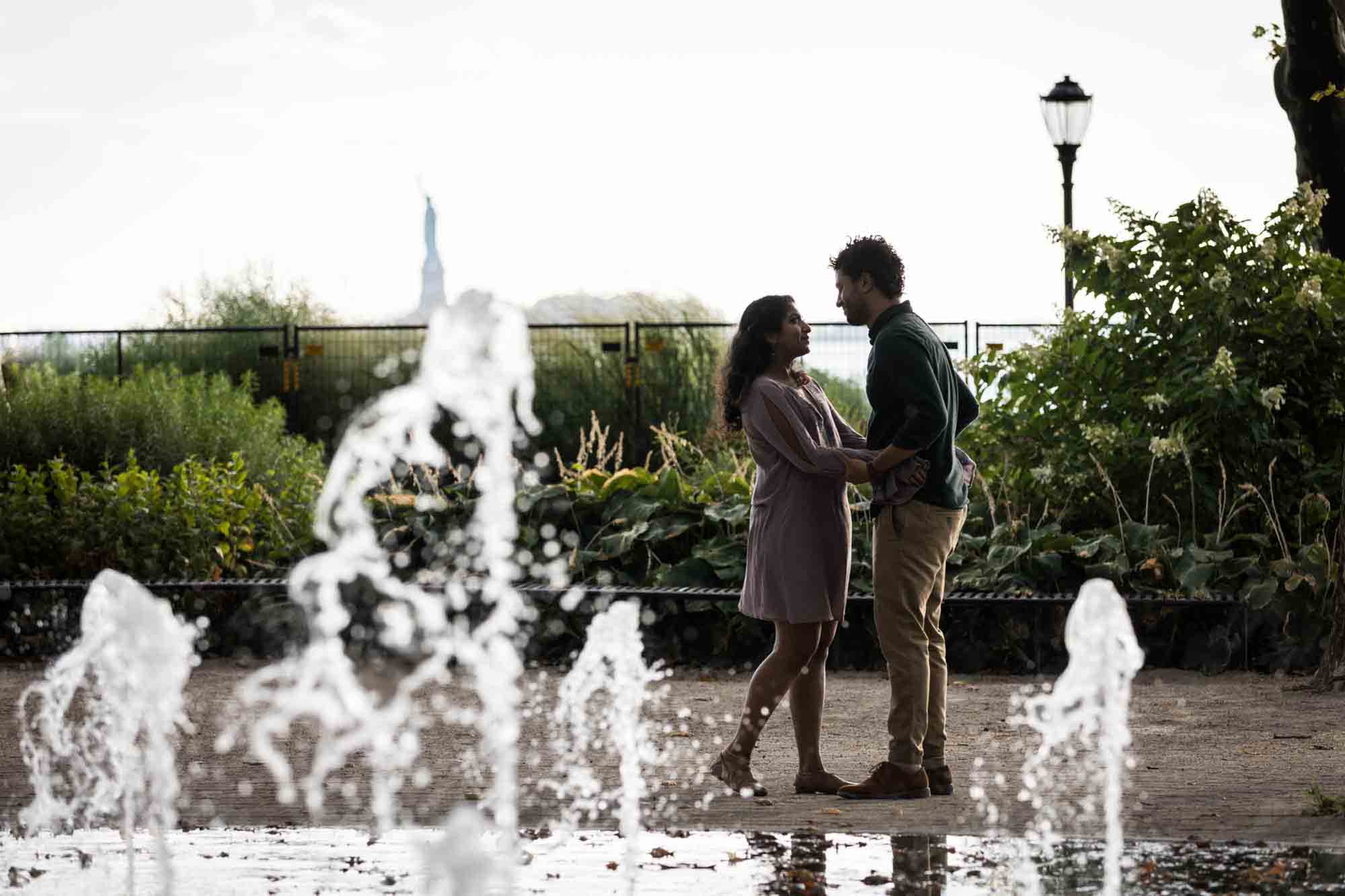 Battery Park engagement photos of couple behind fountain
