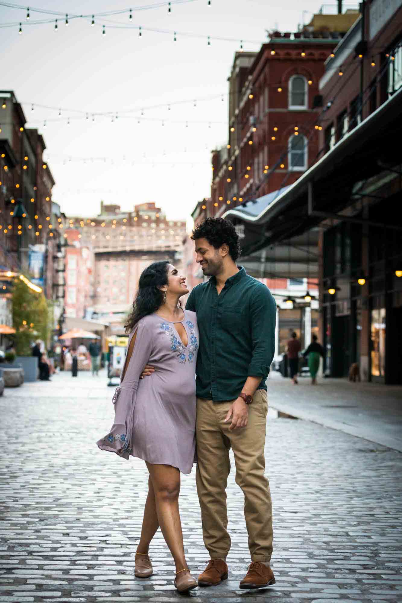 Couple walking on cobblestone street in South Street Seaport