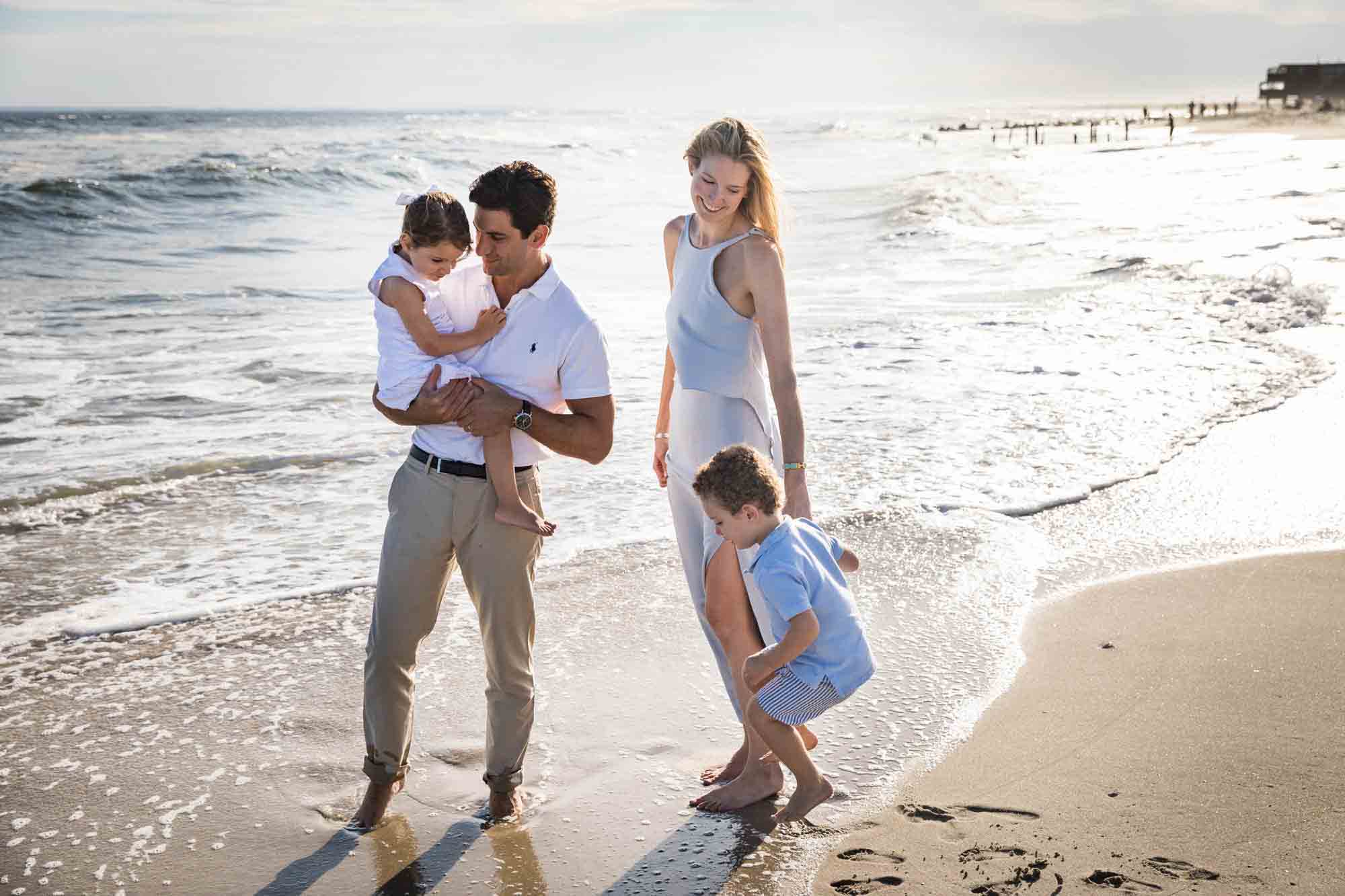 Fort Tilden beach family portrait of family walking along the ocean shore