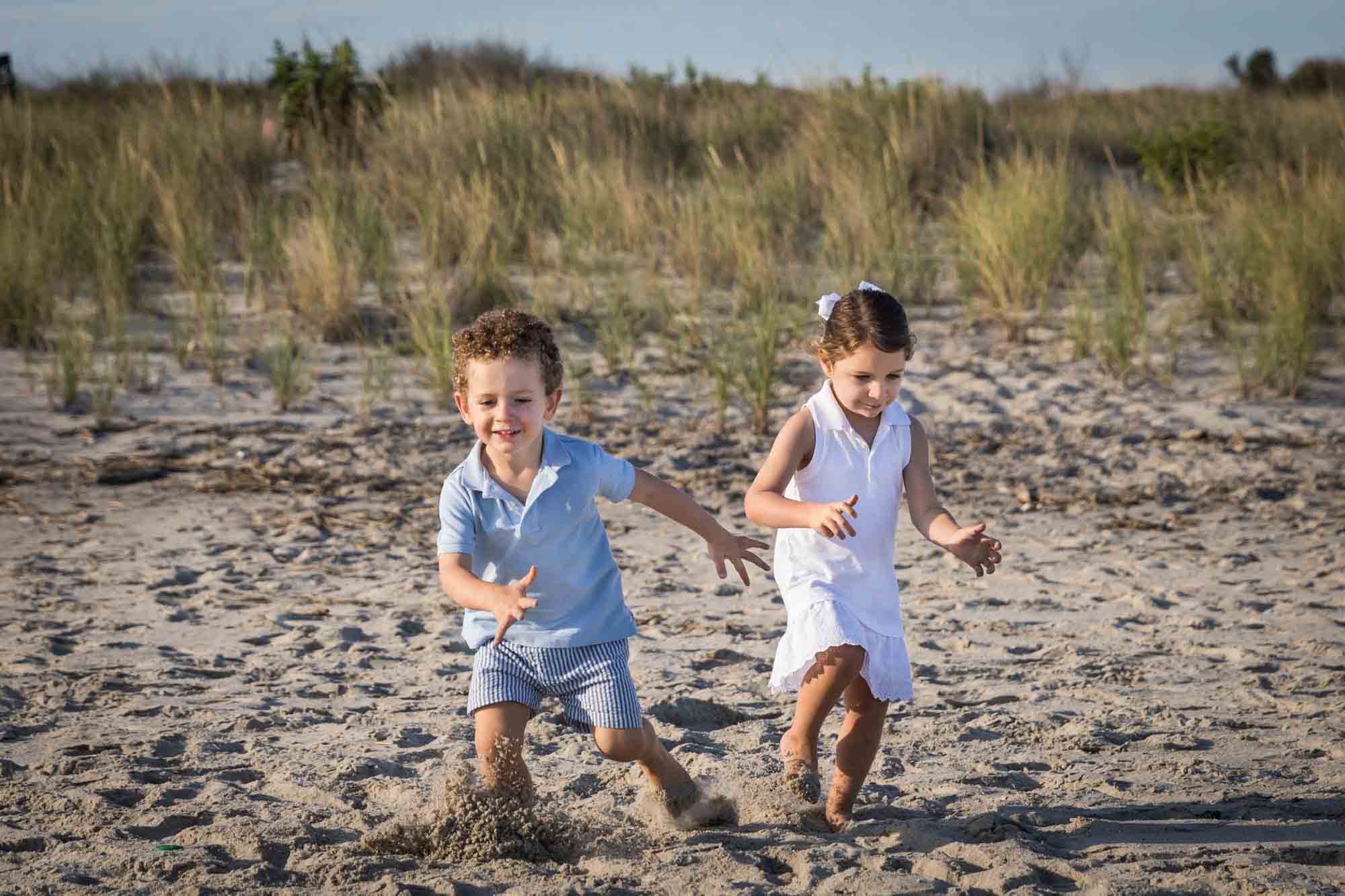 Fort Tilden beach family portrait of two kids running on the beach