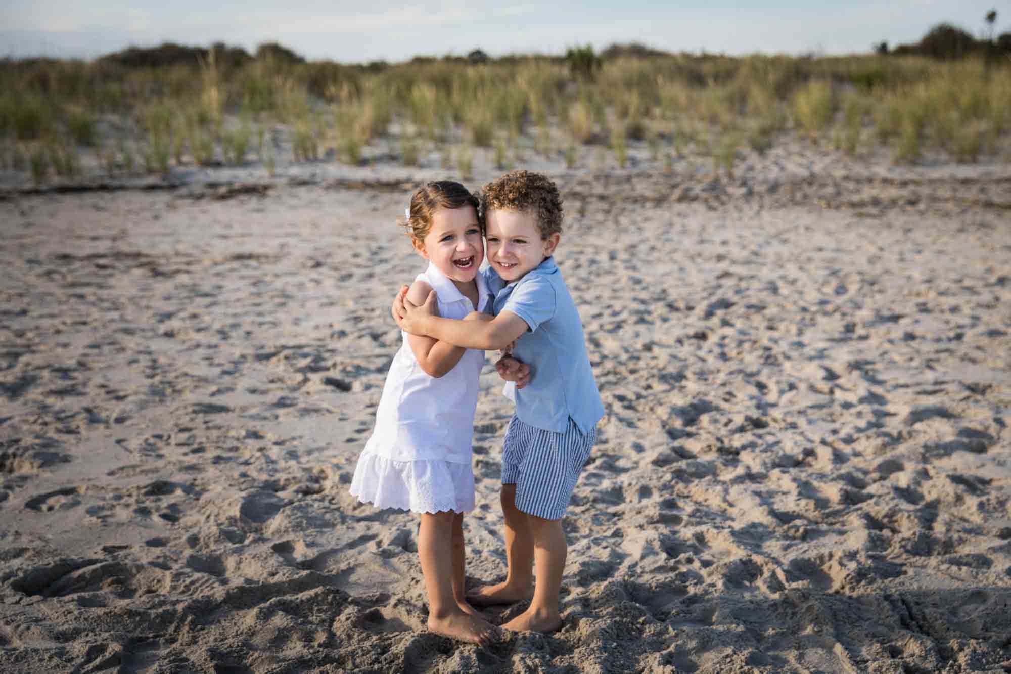 Fort Tilden family portrait of two small children hugging on the beach