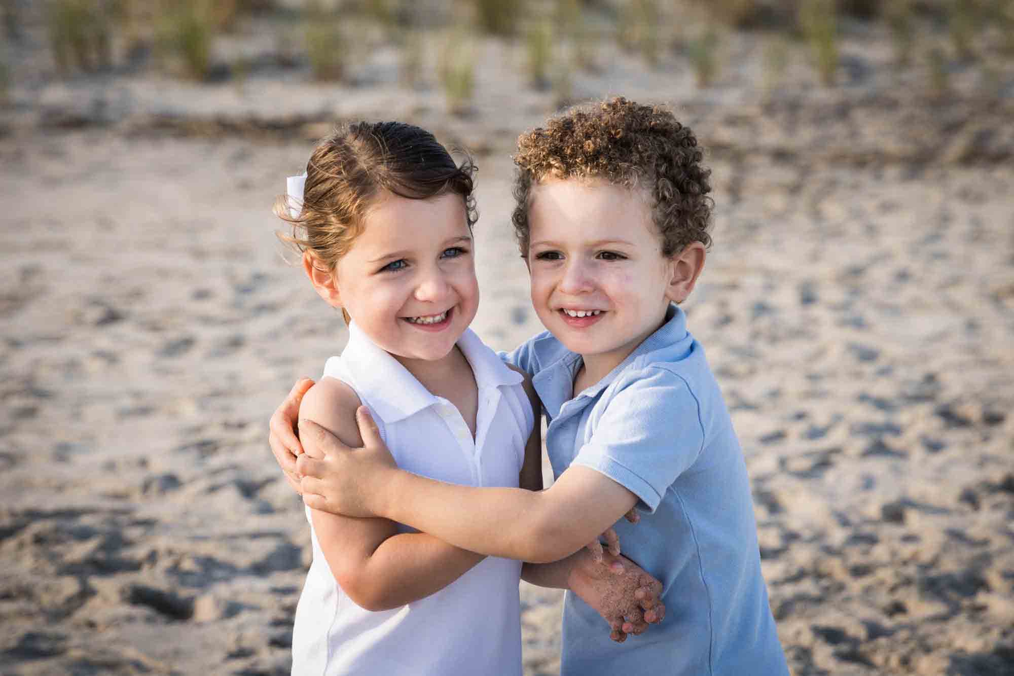 Fort Tilden family portrait of two small children hugging on the beach