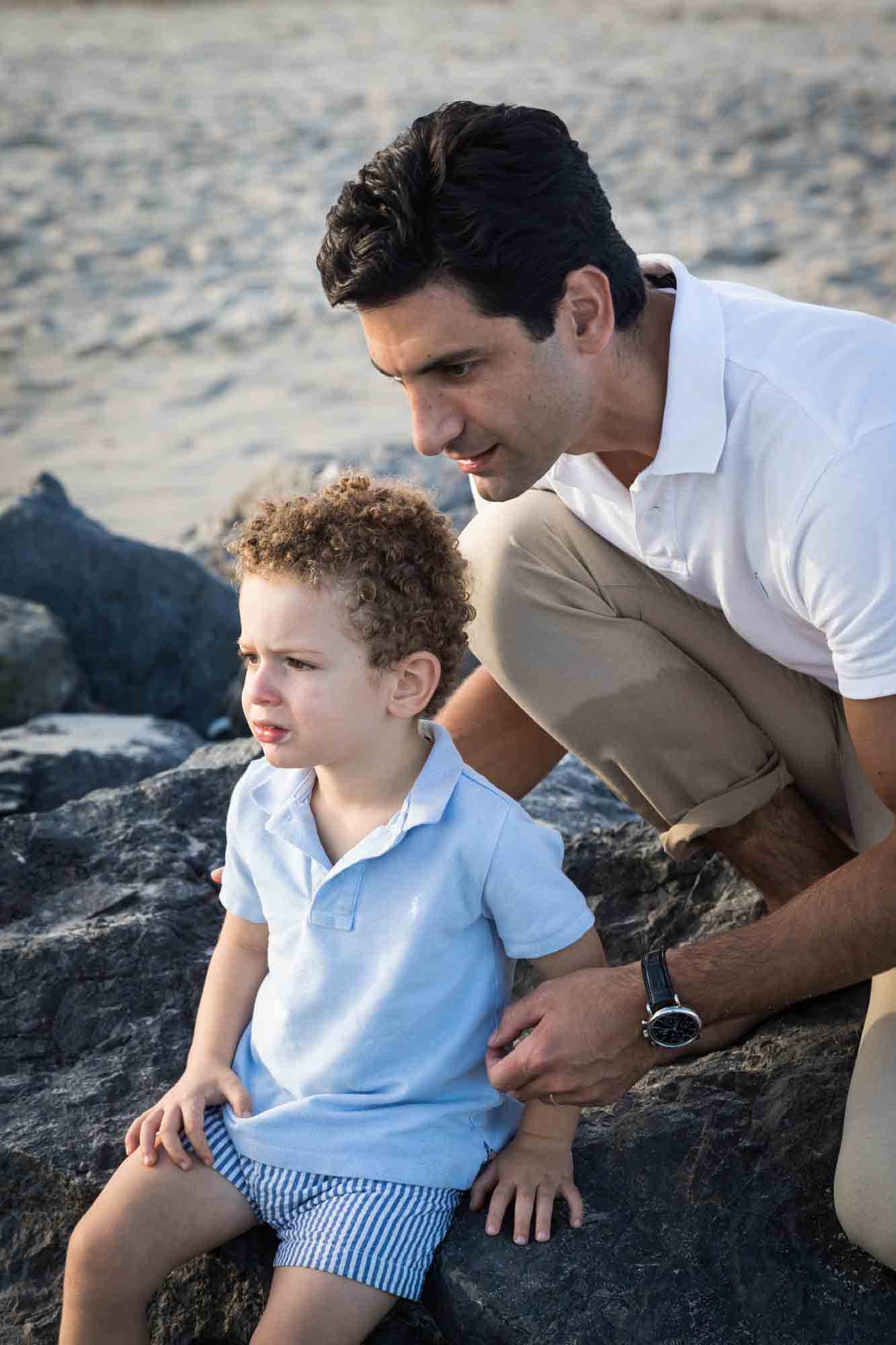 Fort Tilden family portrait of father and son sitting on jetty