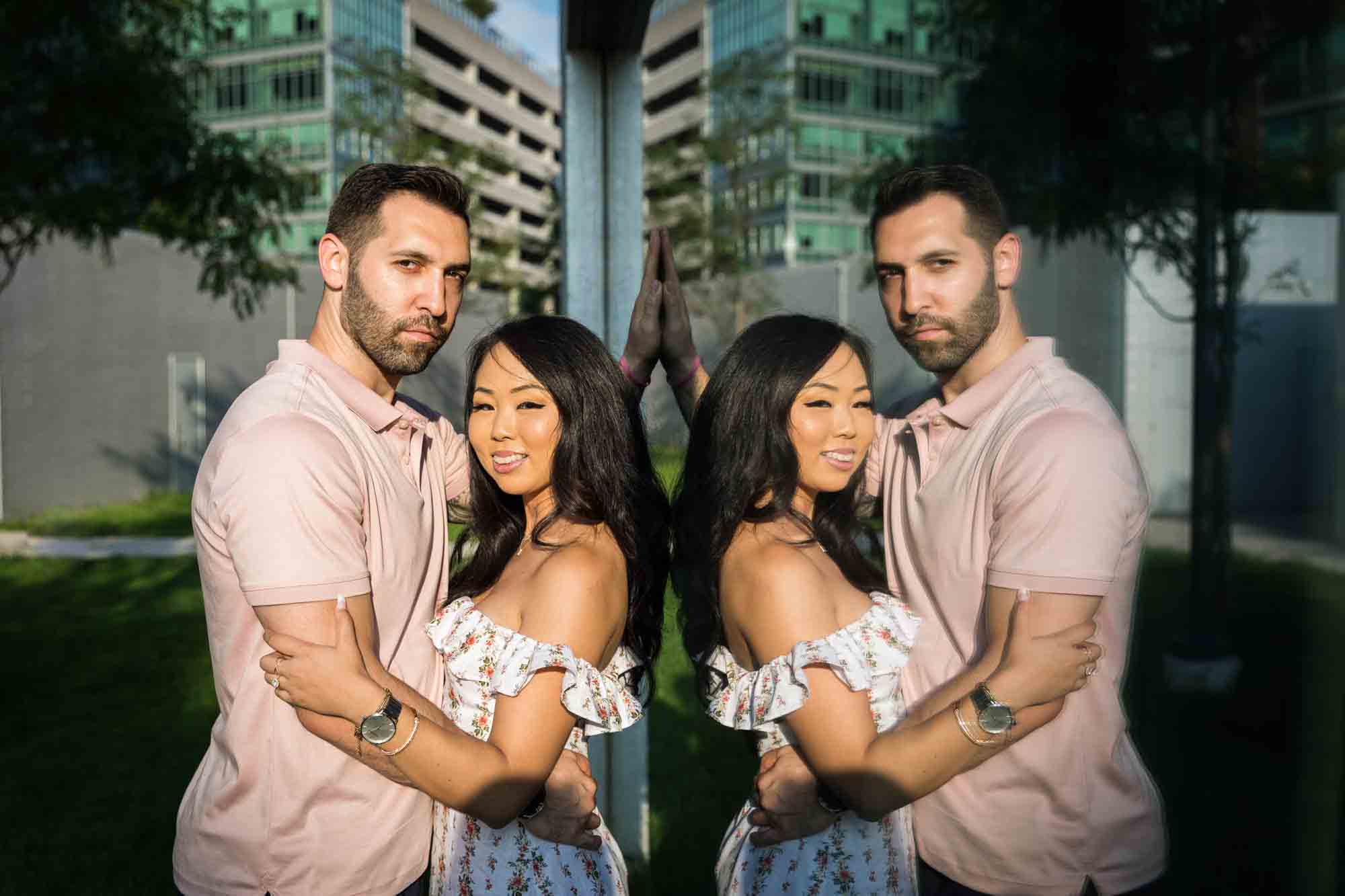 Couple reflected in glass window during Gantry Plaza State Park engagement session for an article on engagement portrait clothing tips