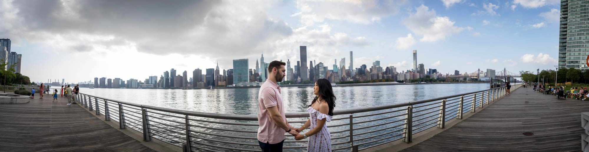 Panorama shot of couple on boardwalk during a Gantry Plaza State Park engagement photo shoot