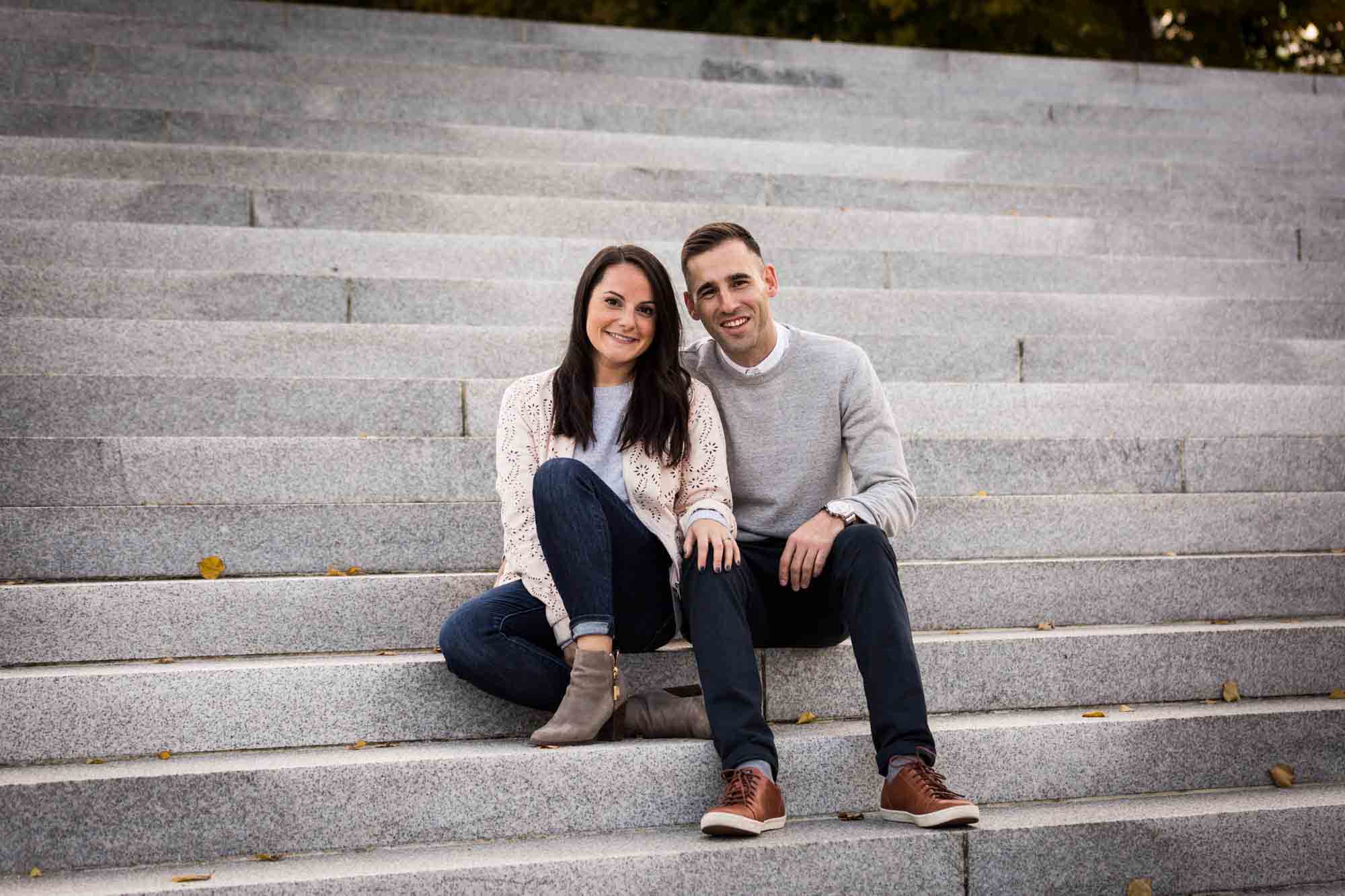 Couple sitting on steps during a Four Freedoms Park engagement photo shoot
