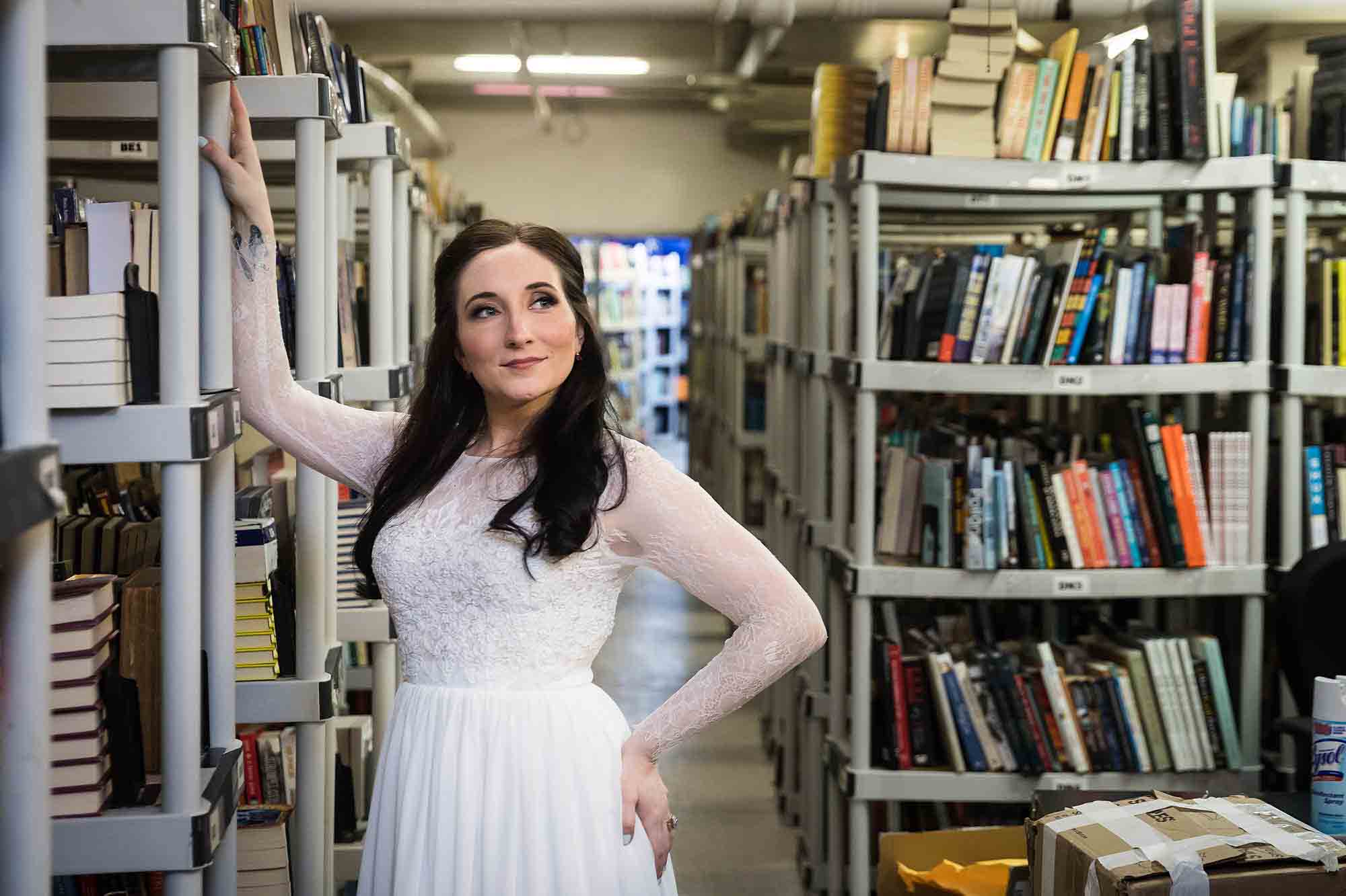 Bride holding on to bookcase at a Housing Works Bookstore wedding