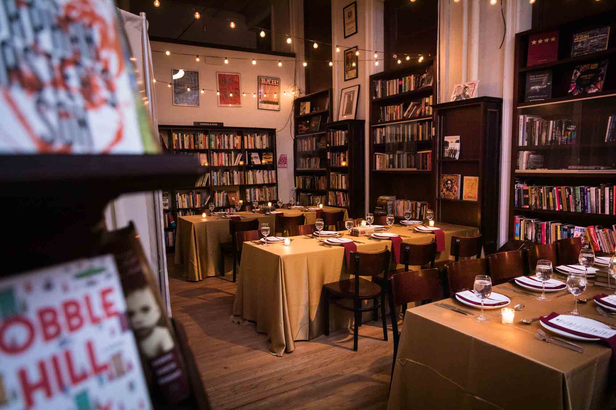 Tables among bookcases at a Housing Works Bookstore wedding