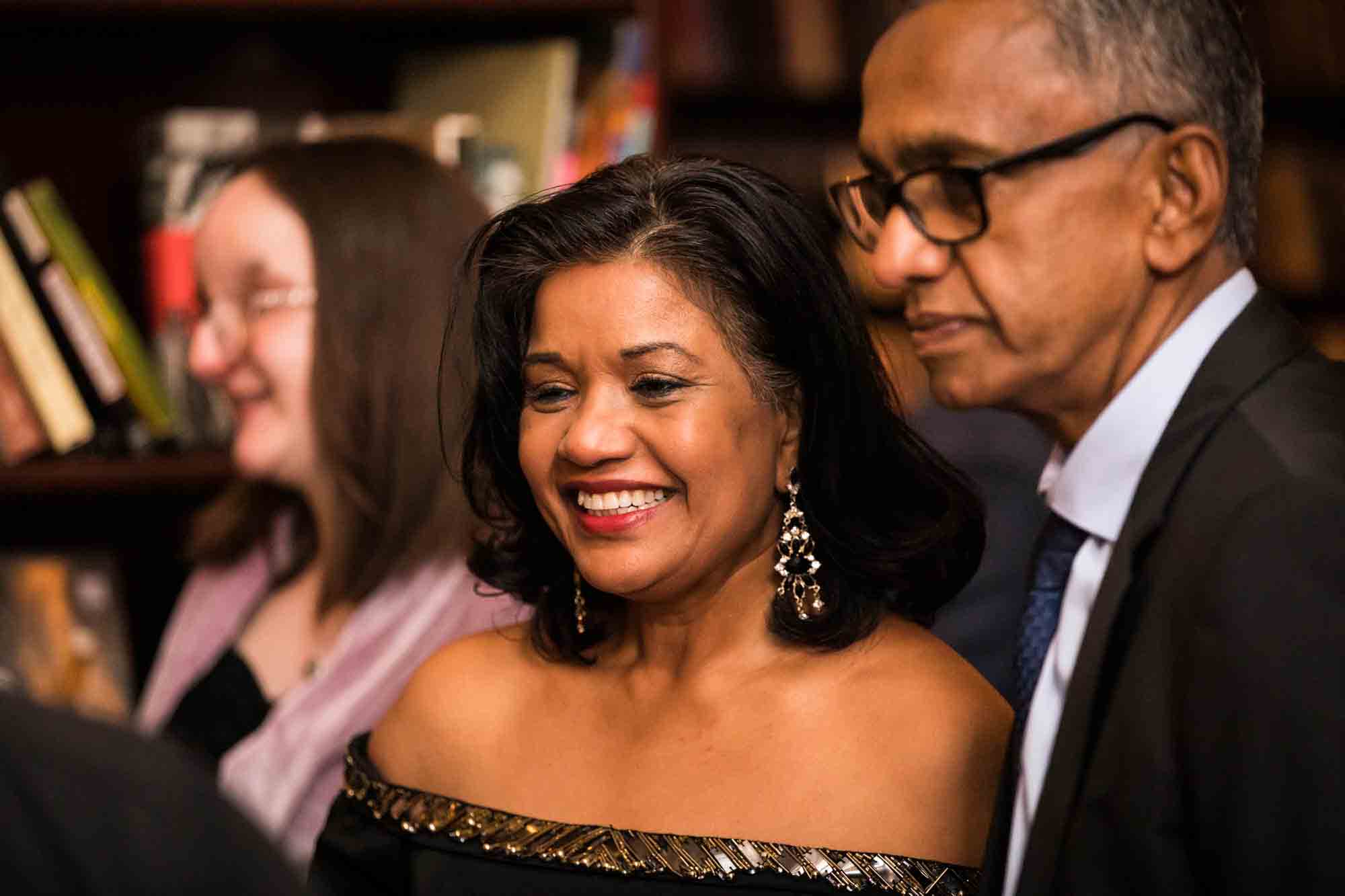 Two female guest and a male guest smiling for an article on wedding ceremony photo tips