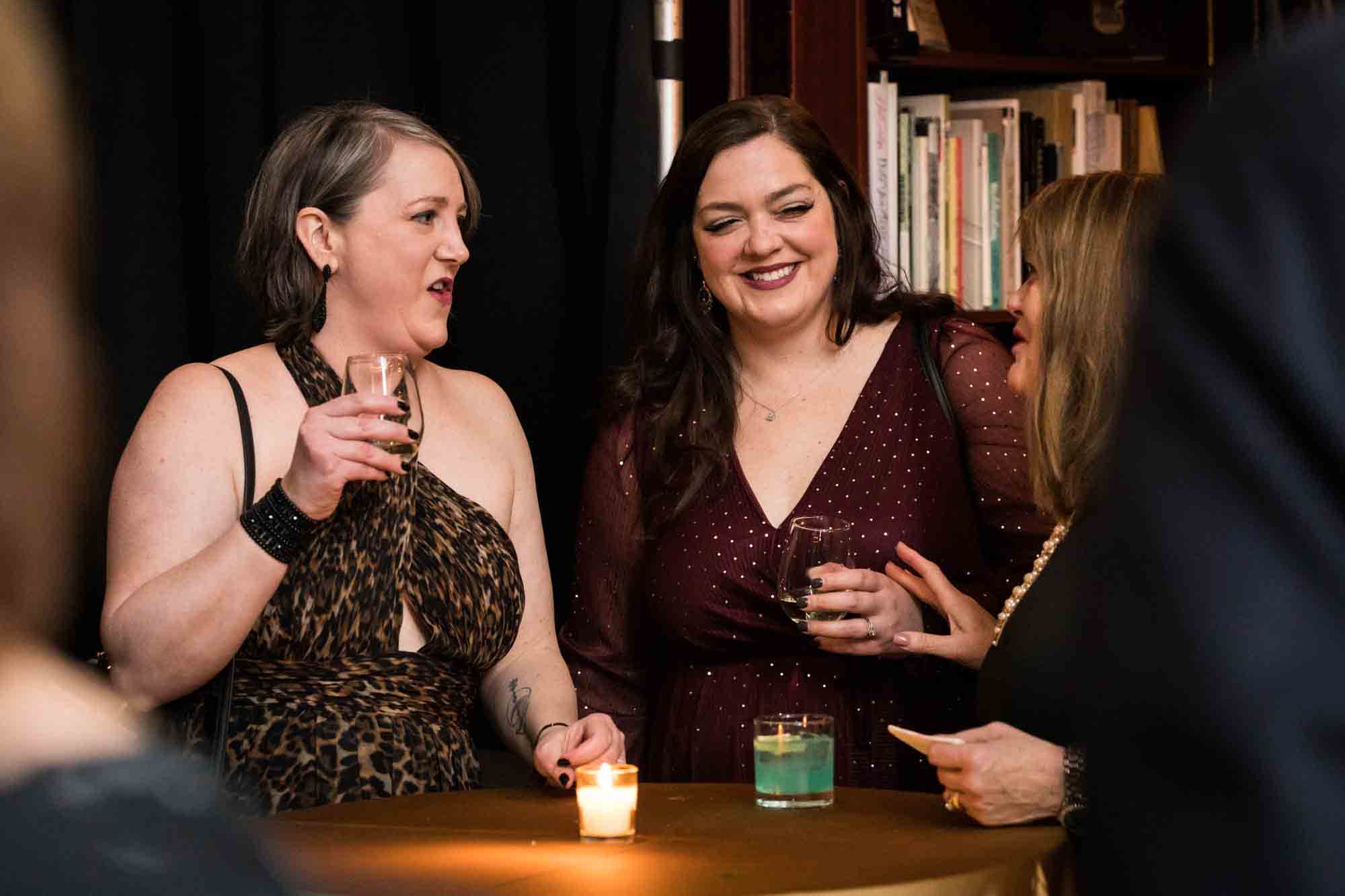 Two female guests smiling for an article on wedding ceremony photo tips