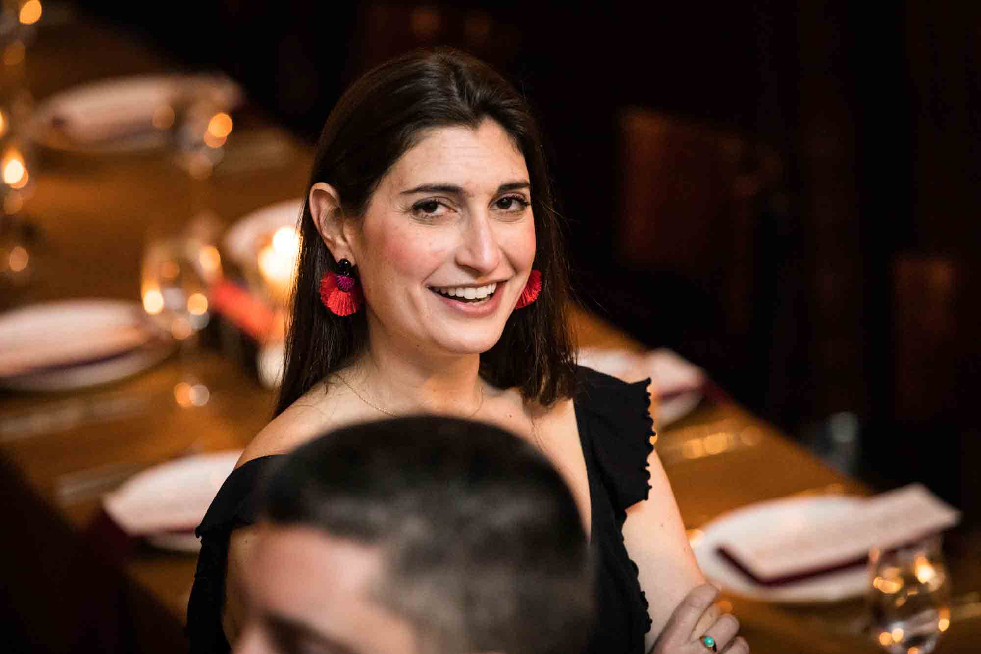 Woman with long brown hair smiling for an article on wedding ceremony photo tips